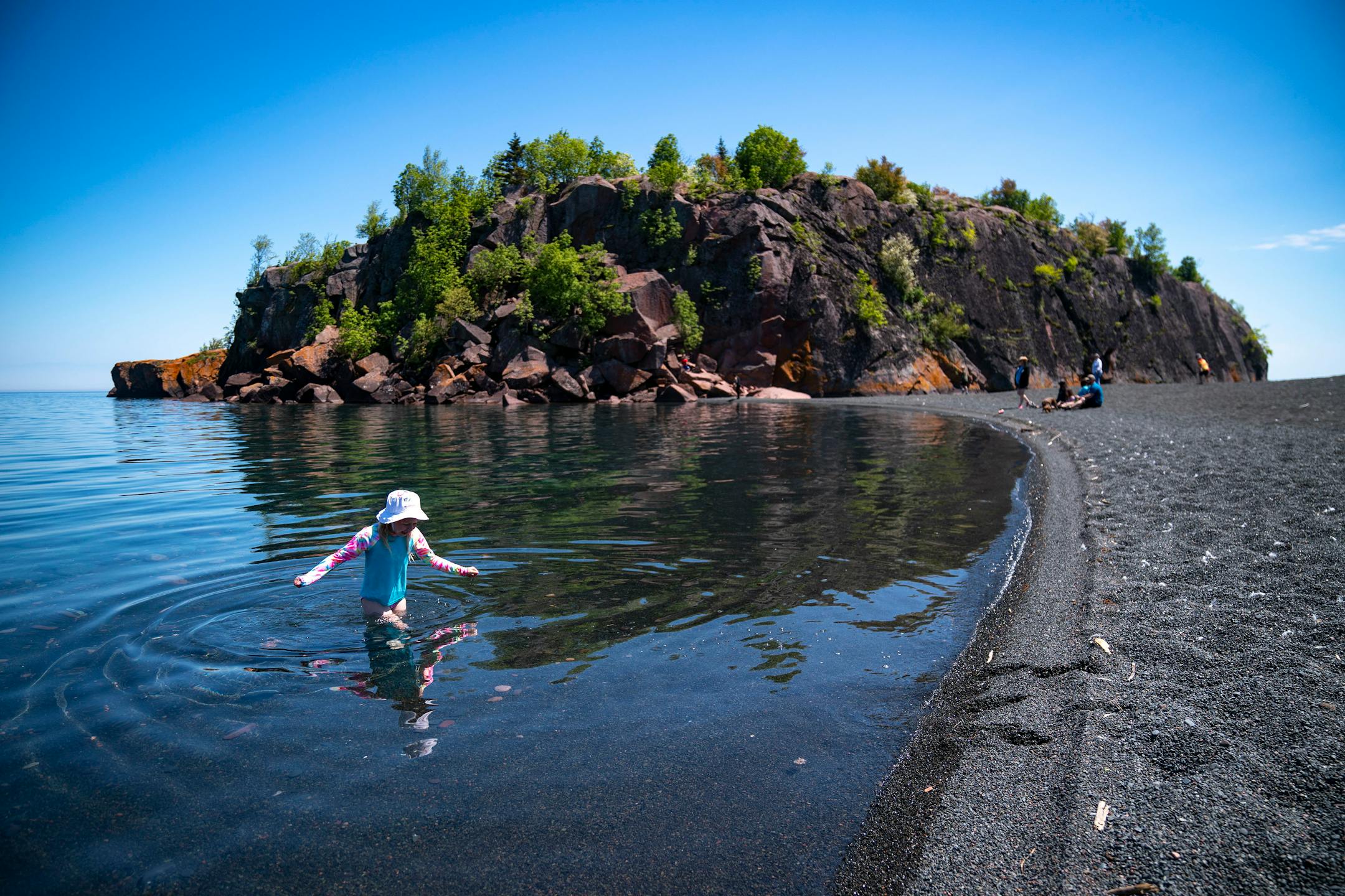 Abiella Gwaltney, 7, from Mankato, Minn. waded out of Lake Superior and towards the shore of Black Beach on Wednesday, June 2, 2021.    ]