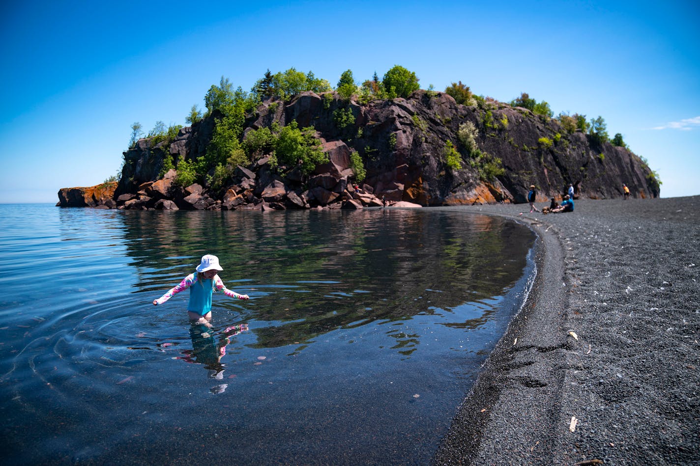 Abiella Gwaltney, 7, from Mankato, Minn. waded out of Lake Superior and towards the shore of Black Beach on Wednesday, June 2, 2021.    ]