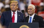 President Donald Trump, left, and Vice President Mike Pence attend a "homecoming" rally at the BBT Center in Sunrise, Fla., on Tuesday, Nov. 26, 2019.