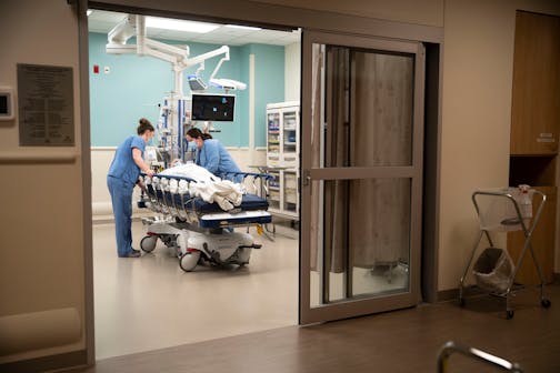 Two nurses set up a patient in his room in St. Luke's Emergency Department in Duluth