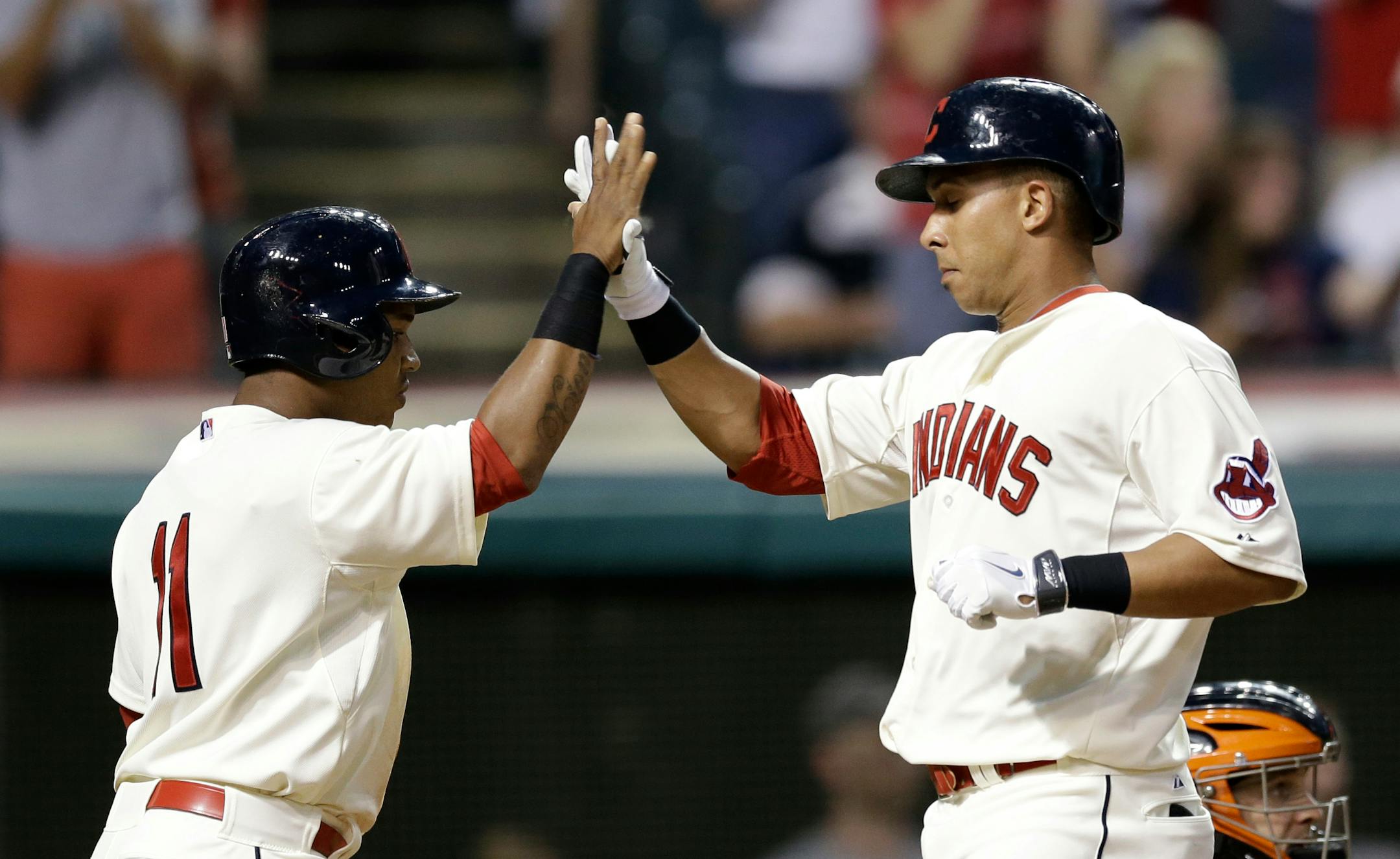Cleveland Indians' Michael Brantley, right, is congratulated by Jose Ramirez after Brantley hit a two-run home run off Baltimore Orioles starting pitcher Ubaldo Jimenez in the fifth inning of a baseball game, Saturday, Aug. 16, 2014, in Cleveland. Ramirez scored on the play. (AP Photo/Tony Dejak)