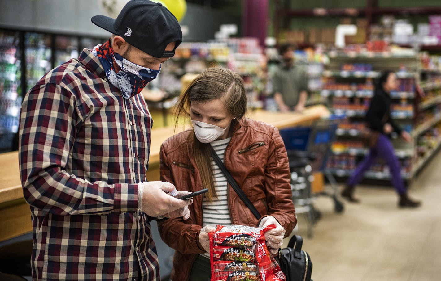 Cody Stuck and Svetlana Fuller shop for ramen. Fuller says it makes him feel better than employees are required to wear masks.] United Noodle, a pan-Asian grocery store requires its employees to wear a mask at work for their own safety and that of customers. RICHARD TSONG-TAATARII &#xa5; richard.tsong-taatarii@startribune.com