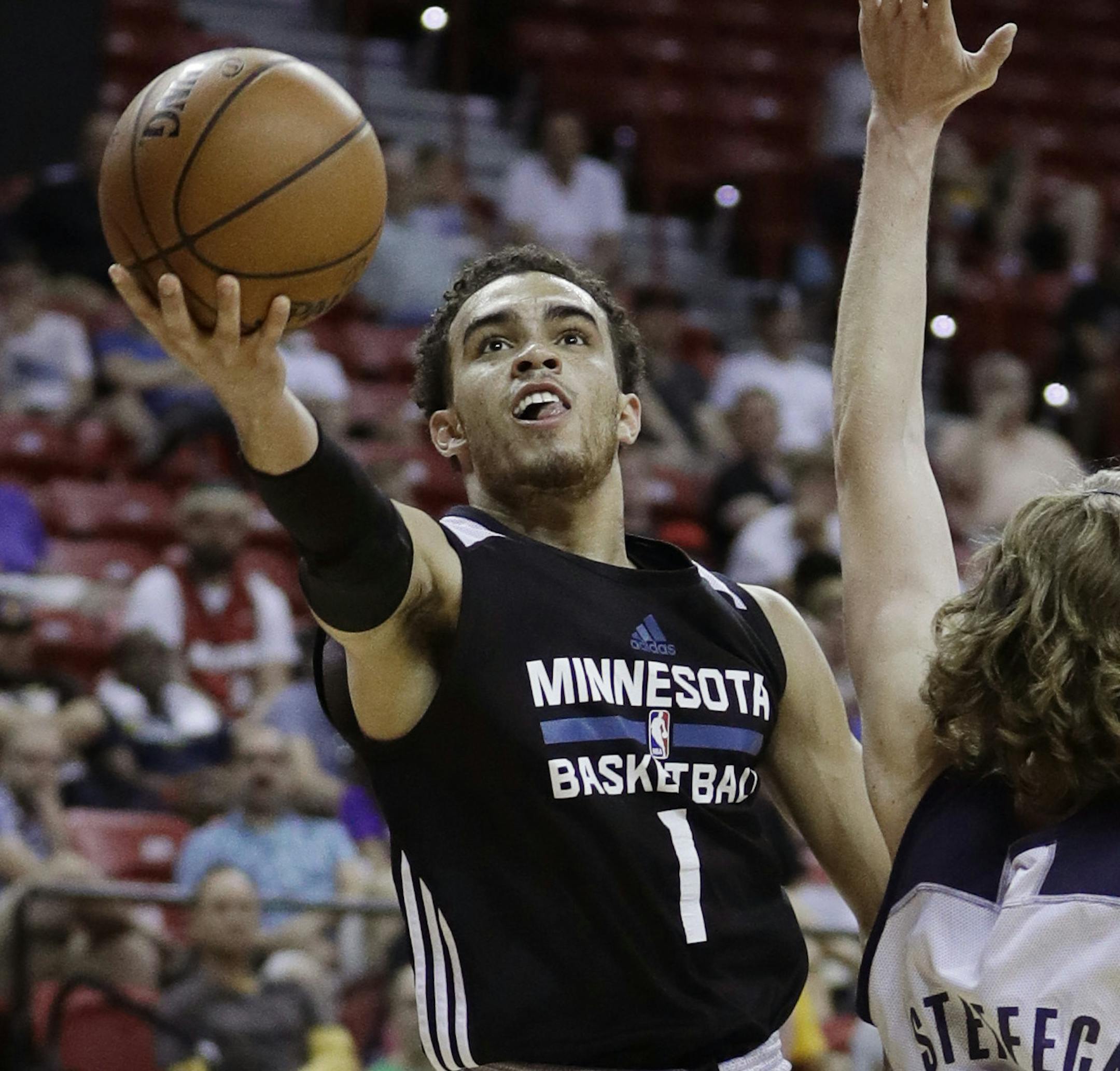 Minnesota Timberwolves' Tyus Jones shoots around Memphis Grizzlies' Keith Steffeck during the second half of an NBA summer league basketball game Thursday, July 14, 2016, in Las Vegas. (AP Photo/John Locher)
