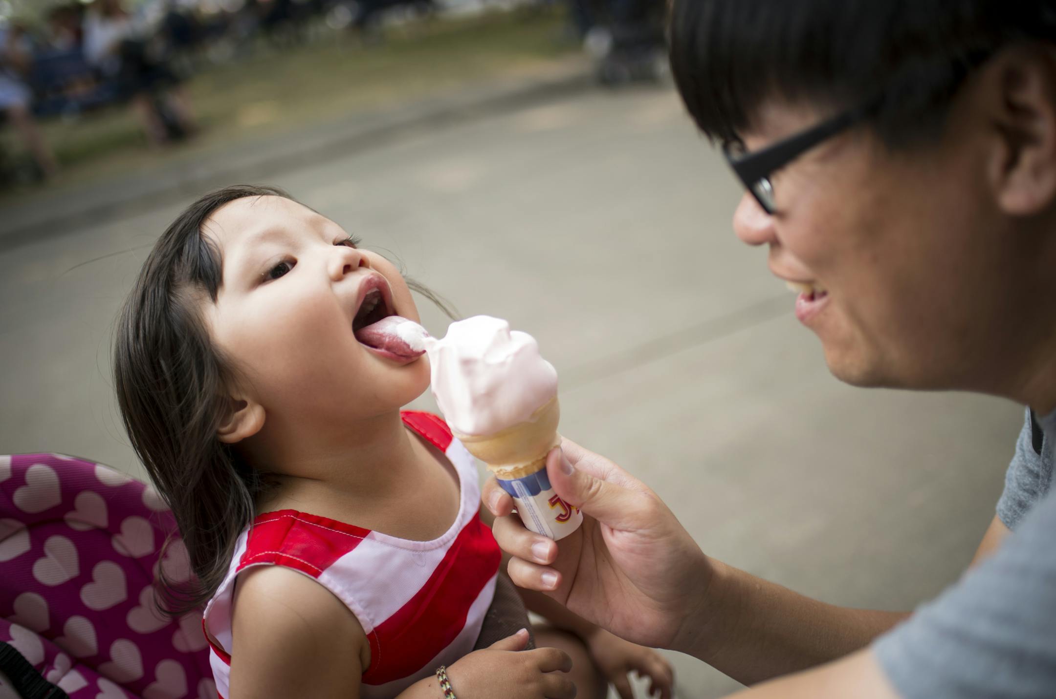Mia Chang, age 2, helped her father, River Chang, polish off a cone filled with vanilla frozen custard from Custard&#x2019;s Last Stand at the Minnesota State Fair.