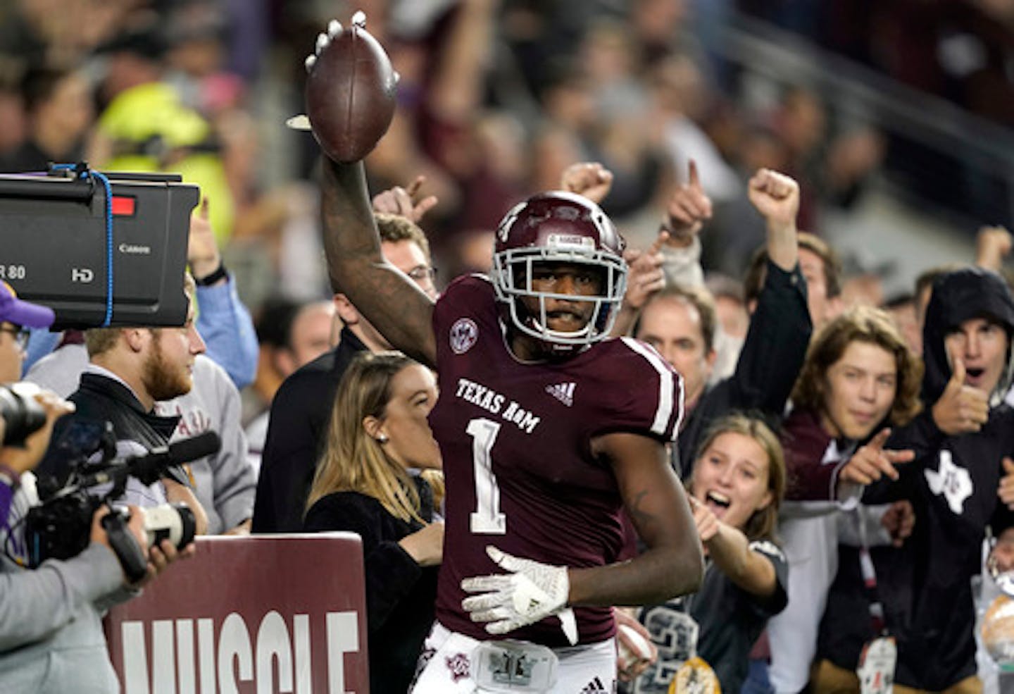 FILE - In this Nov. 24, 2018, file photo, Texas A&M wide receiver Quartney Davis (1) celebrates after catching a touchdown pass during the seventh overtime of an NCAA college football game against LSU, in College Station, Texas. Texas A&M won 74-72. The NCAA football rules committee has proposed giving replay officials more leeway to overturn targeting fouls and recommended that games reaching a fifth overtime period be decided by alternating 2-point conversion tries. The rules committee met in Indianapolis this week and announced on Friday, March 1, 2019,its proposed changes, including tweaks to kickoffs and blind-side blocks. The proposals must be approved by the football oversight committee in April. They would go into effect next season.(AP Photo/David J. Phillip, File) ORG XMIT: NY166