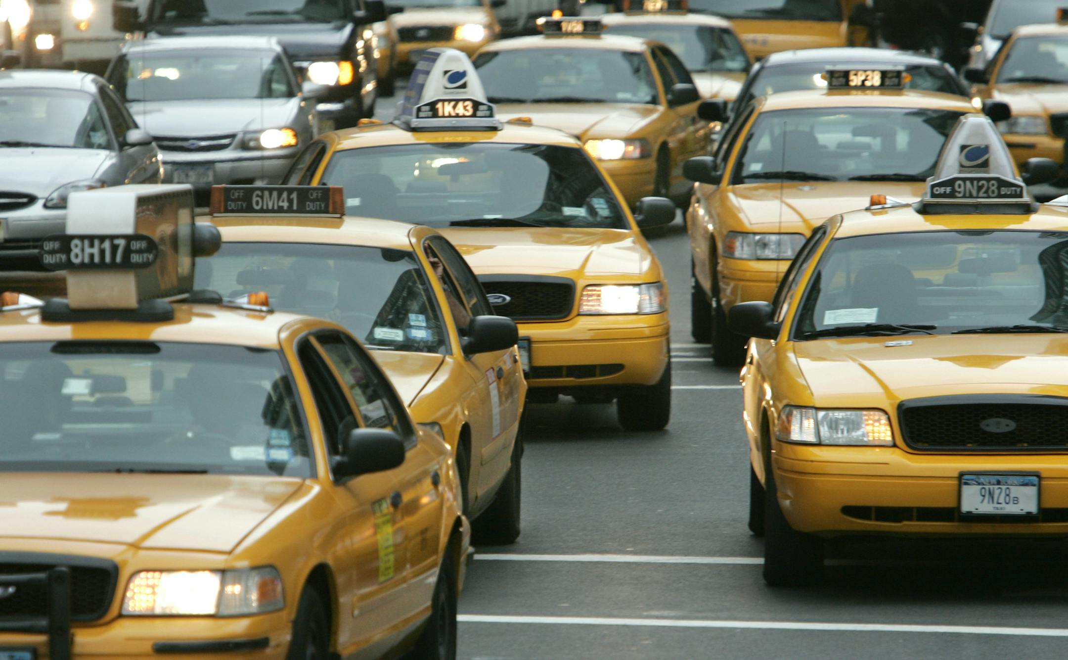 New York City taxis move uptown on Manhattan's 8th Ave., Tuesday Oct. 4, 2005. Taxi regulators have been exploring the possibility of requiring all city cabs to come equipped with GPS devices, which can be used to pinpoint a vehicle's exact location using signals from satellites. But the potential cost of such a system has bothered some drivers, already squeezed by rising fuel prices. (AP Photo/Richard Drew) ORG XMIT: NYR102