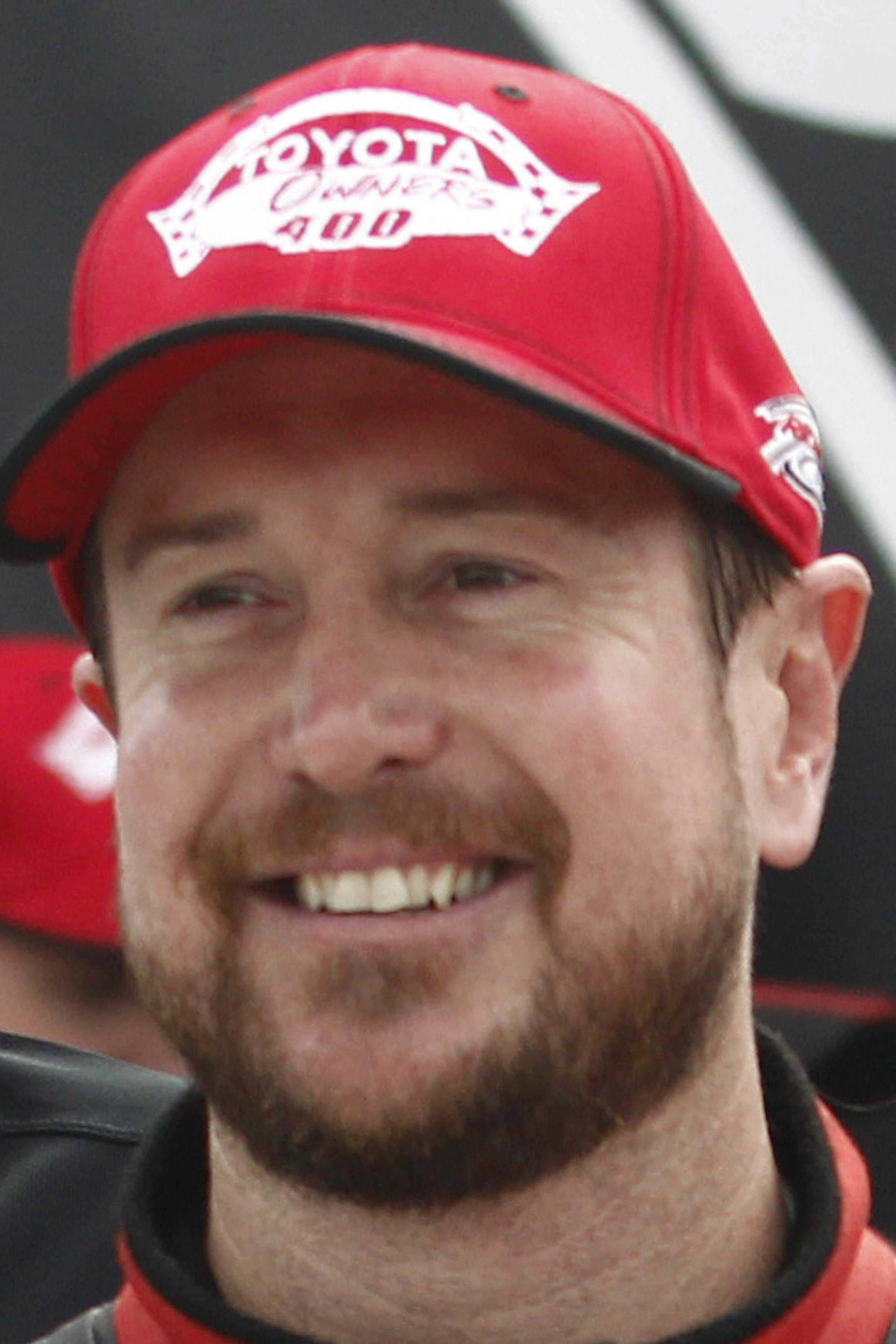 Kurt Busch, second from left, stands with the trophy after winning the NASCAR Sprint Cup auto race at Richmond International Raceway in Richmond, Va., Sunday, April 26, 2015. (AP Photo/Scott P. Yates)