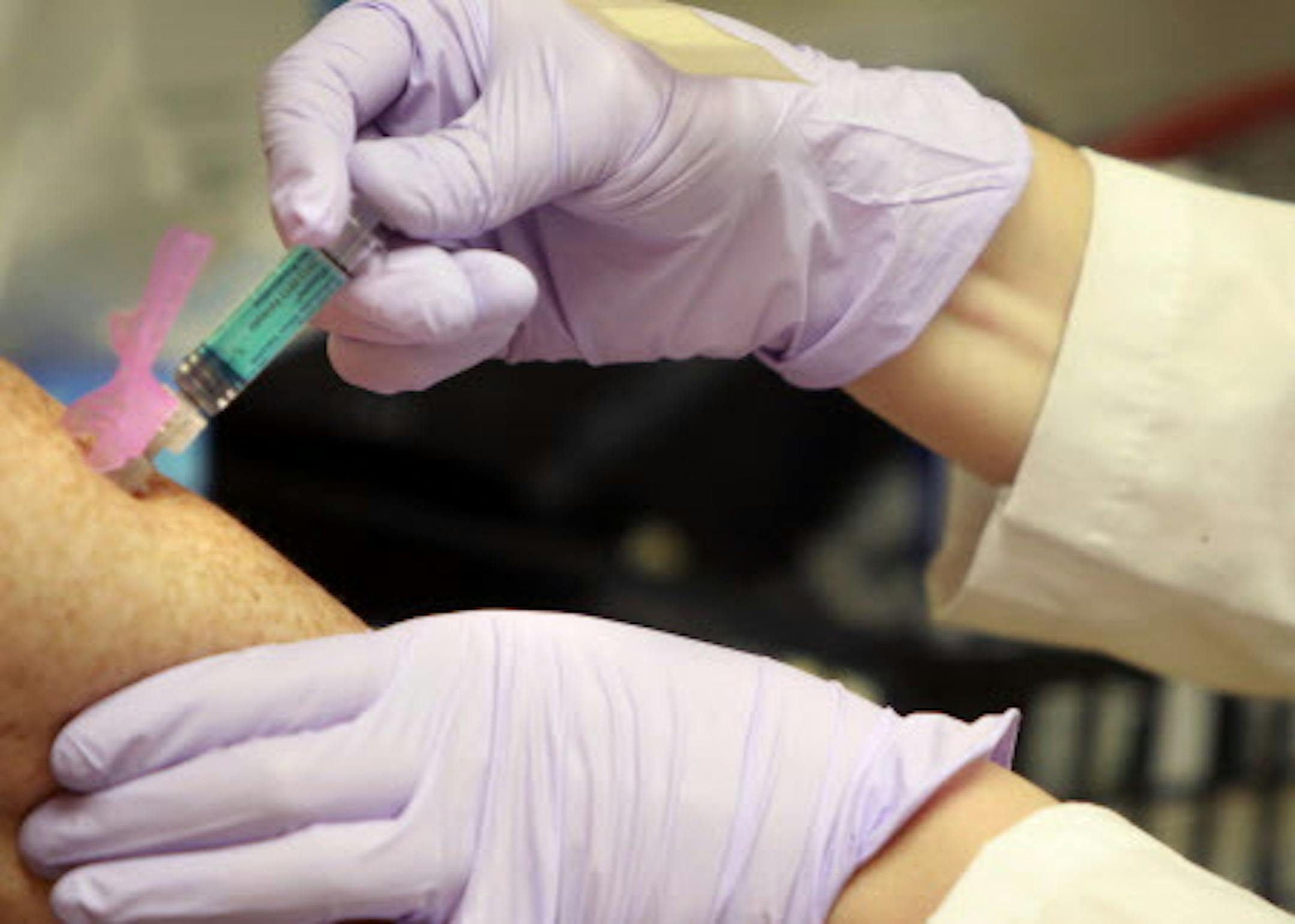 Mara Glantz, RN, CNP, gave patient Page Cowles a flu shot Thursday, October 4, 2012 in St. Paul, MN. As millions gain insurance under the new health law, many will head to clinics for health care. Target, MinuteClinic and others are already ramping up what they offer.(ELIZABETH FLORES/STAR TRIBUNE) ELIZABETH FLORES • eflores@startribune.com