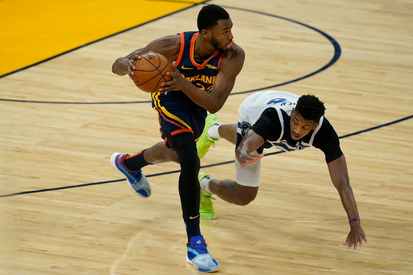 Golden State Warriors forward Andrew Wiggins, left, grabs the ball in front of Minnesota Timberwolves guard Jarrett Culver during the first half of an NBA basketball game in San Francisco, Monday, Jan. 25, 2021. (AP Photo/Jeff Chiu)