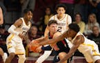 Caleb Williams, surrounded by Gophers, still puts up 41 points in Macalester's exhibition loss at Williams Arena last Nov. 2.