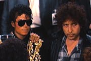 Michael Jackson and Bob Dylan record their parts at a Los Angeles studio for the charity single "We Are the World" in 1985.