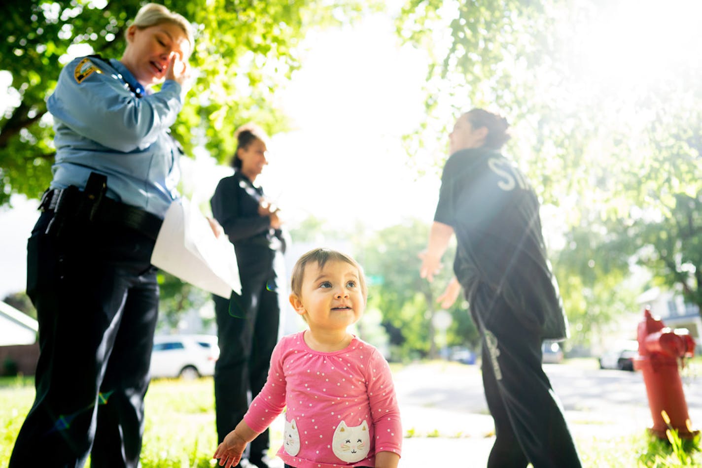 Reservists with the St. Paul Police Department canvassed blocks near Rice Street and Winnipeg Avenue W. on Friday. The neighborhood was the scene of a recent fatal shooting.