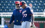 Minnesota Twins bullpen coach Eddie Guardado (18) patted pitching prospect Fernando Romero (77) on the back after Romero finished pitching during live