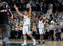 Michigan State's Miles Bridges (22) and Joshua Langford (1) celebrate following a 68-65 win over Purdue in an NCAA college basketball game, Saturday, 