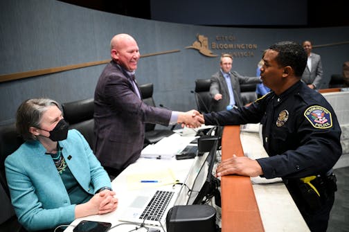 Bloomington Police Chief Booker T. Hodges shakes hands with City Manager Jamie Verbrugge after Hodges' swearing in ceremony Monday, April 11, 2022 at the Bloomington Civic Plaza in Bloomington, Minn.