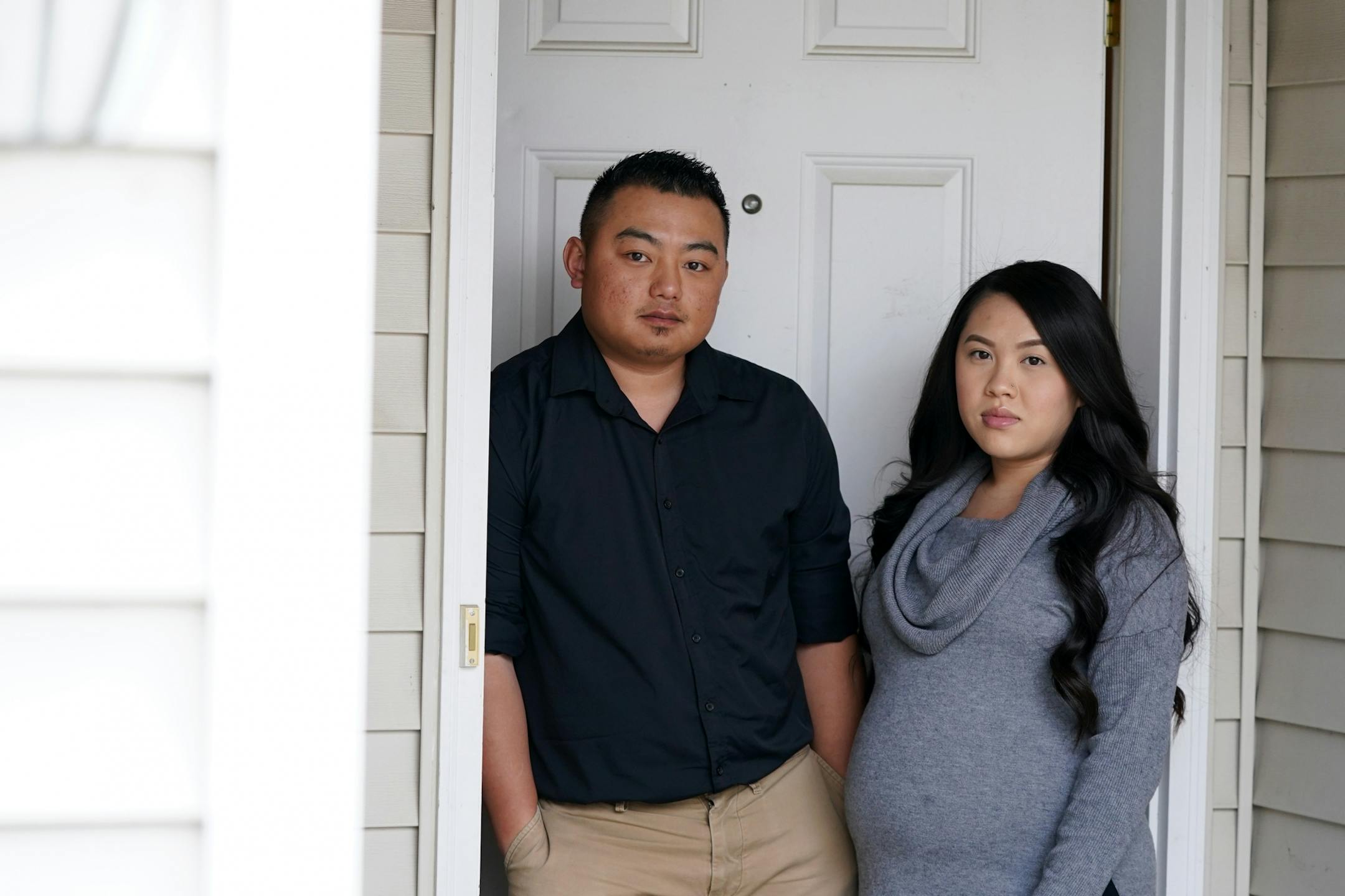 Alvin Moua and his wife Vanishia Yang stood for a portrait outside their home where someone left a racist, threatening note on their door linking them to the Coronavirus pandemic Friday.