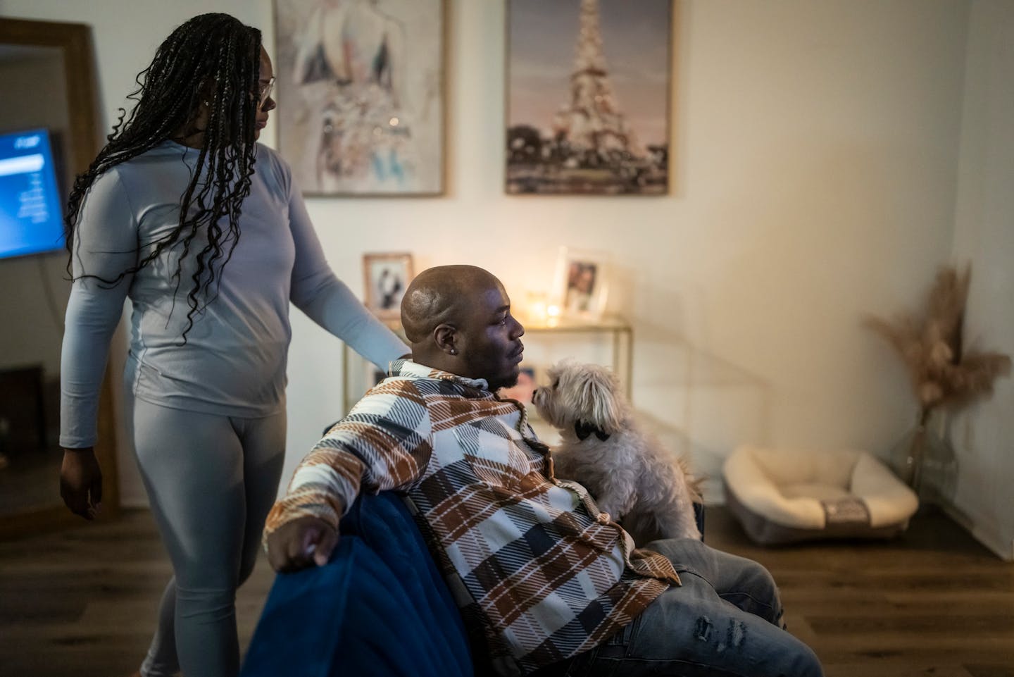 Shannon Haynes tries to comfort Marvin Haynes who was emotional after watching his original interrogation video when he was sixteen on YouTube at his home while his girlfriend's dog tries to comfort him in New Brighton, Minn. on Monday, February 5, 2024.
