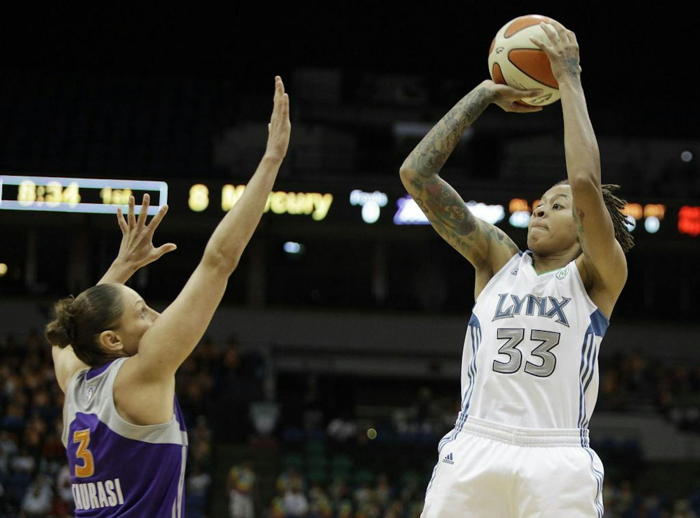 Minnesota Lynx guard Seimone Augustus (33) goes up for shot against Phoenix Mercury guard Diana Taurasi (3) in the first half of a WNBA Basketball game, Wednesday, July 13, 2011, in Minneapolis.