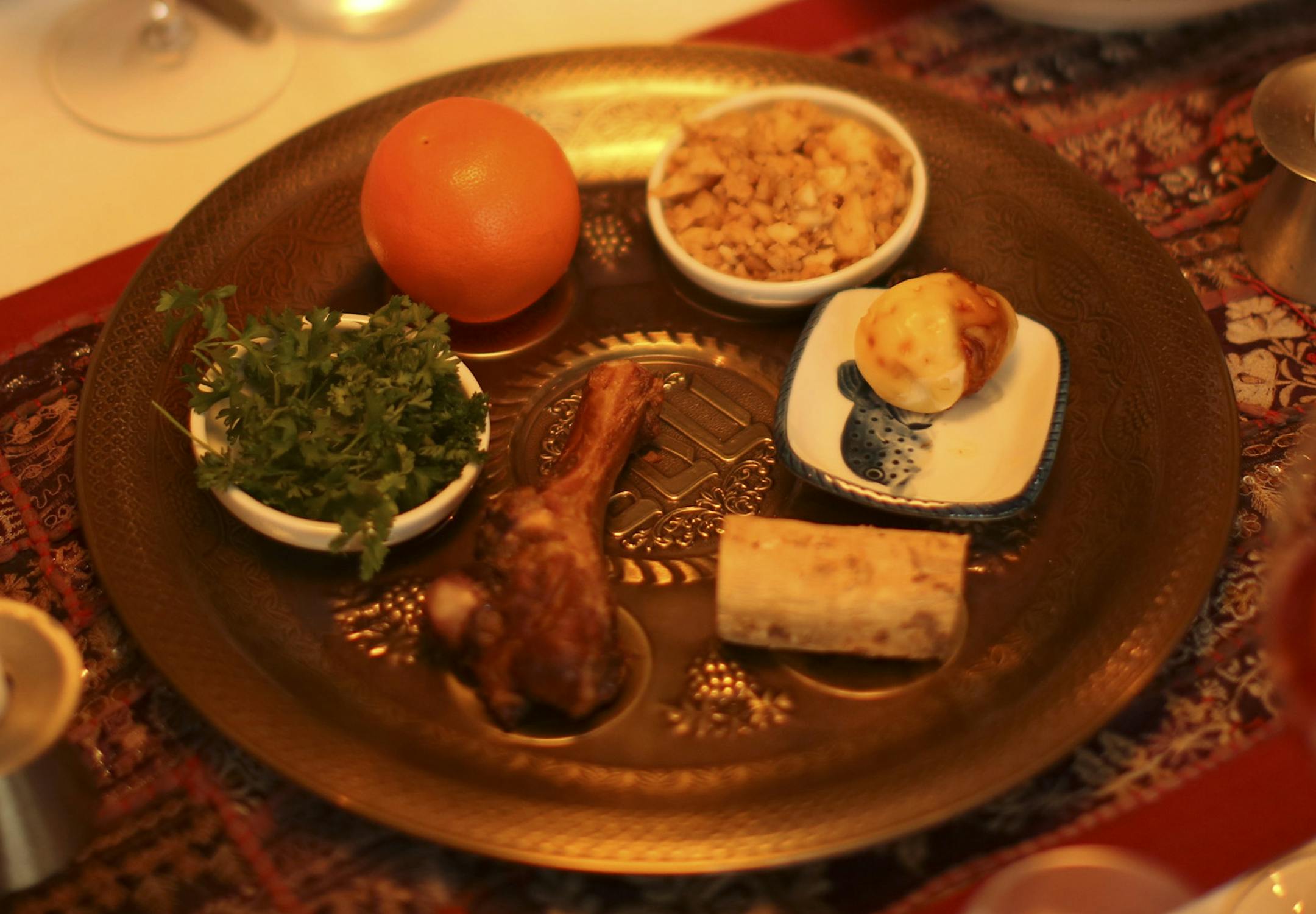The plate in the center of the table held the traditional seder foods of lamb, karpas, and charoset Monday evening. ] JEFF WHEELER ‚Ä¢ jeff.wheeler@startribune.com Kathryn Klibanoff and her husband, Jeremy Pierotti, hosted a musical seder they called "Passover on Broadway" Monday night, April 14, 2014 in their Minneapolis home. They followed the traditional guide for the night's meal, the Haggadah, which relates the story of the Israelite exodus from Egypt, interspersed with Pas
