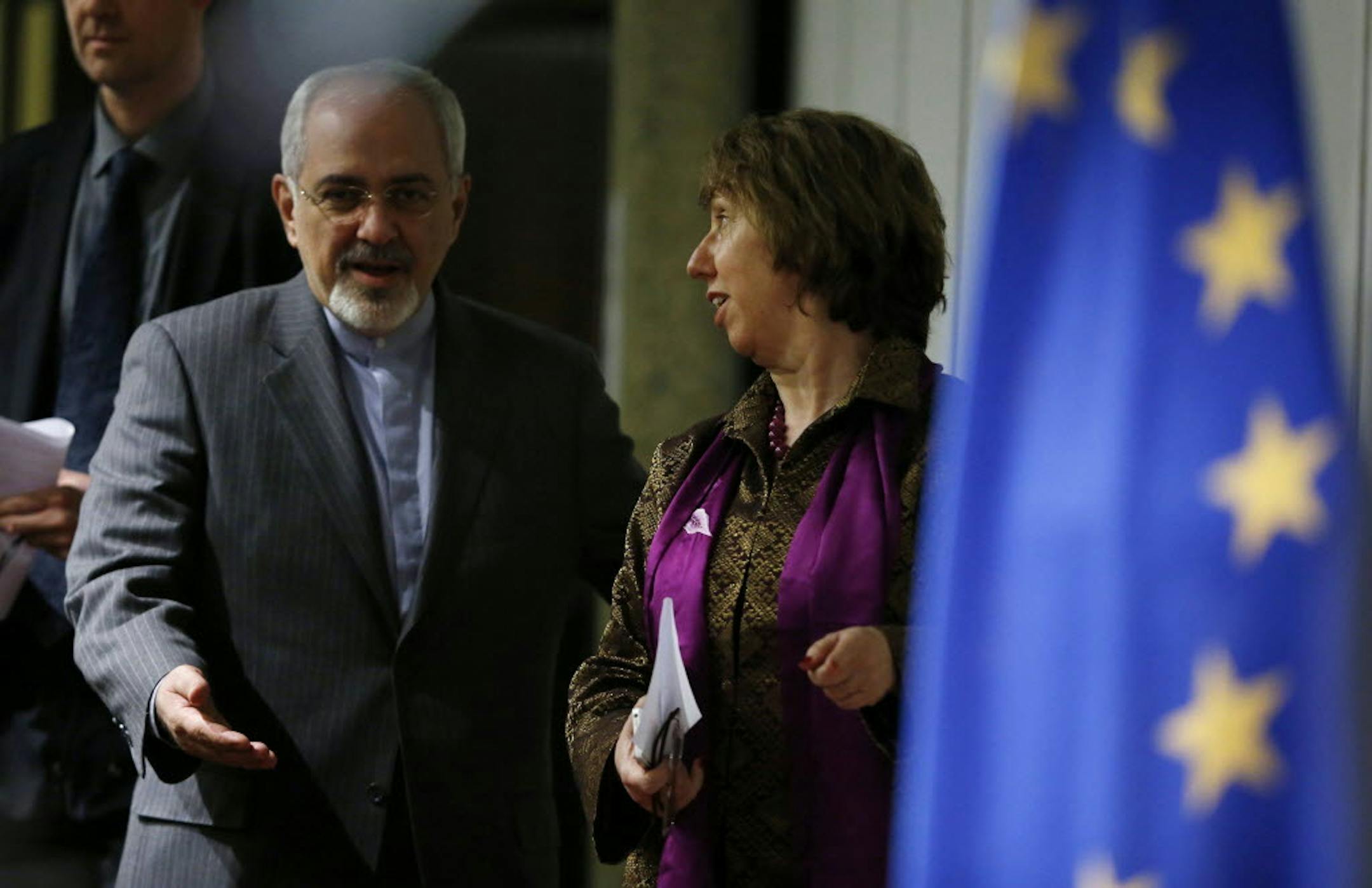 Iranian Foreign Minister Mohammad Javad Zarif, left, gestures to Catherine Ashton, the European Union's foreign policy chief, as they arrive at a press conference at the end of the Iranian nuclear talks in Geneva, Sunday, Nov. 10, 2013.