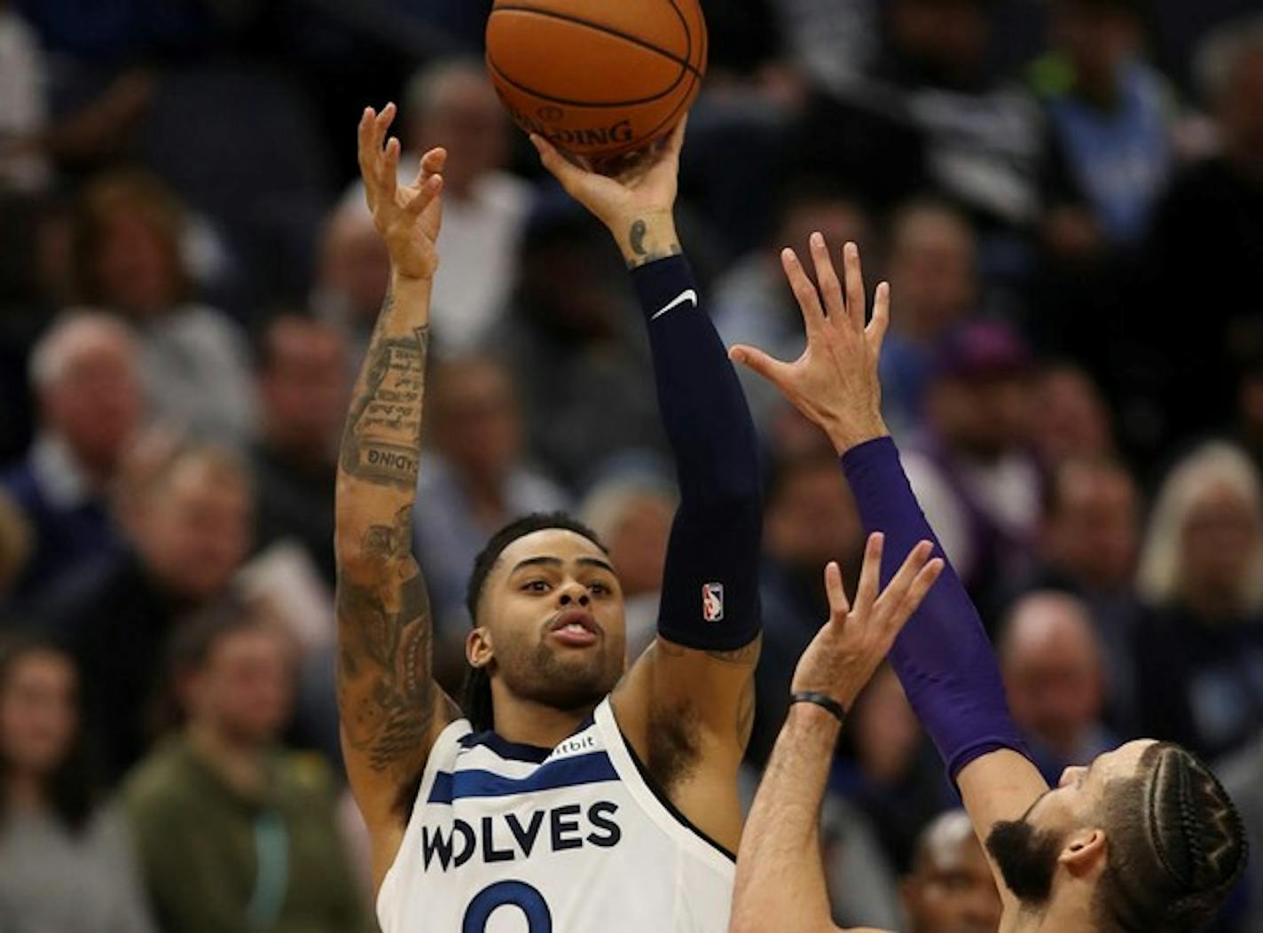 The Minnesota Timberwolves' D'Angelo Russell (0) hit a fourth-quarter shot while defended by the Charlotte Hornets' Caleb Martin (10) on Wednesday, Feb. 12, 2020, at Target Center in Minneapolis. The Hornets won, 115-108. (Jeff Wheeler/Minneapolis Star Tribune/TNS) ORG XMIT: 1571588