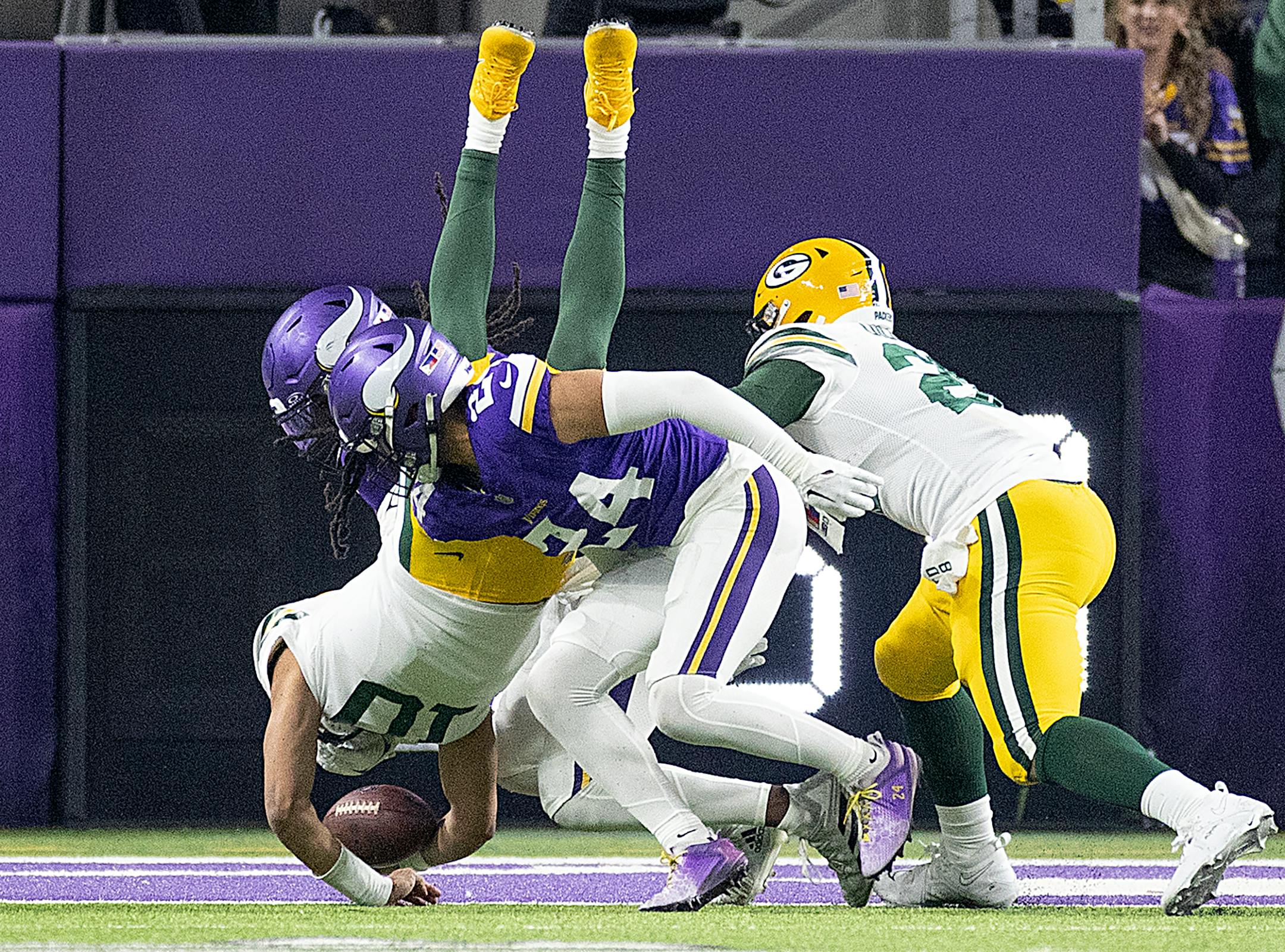 Packers quarterback Jordan Love (10) jumps into the end zone for a touchown in the second quarter at U.S. Bank Stadium, in Minneapolis, Minn., on Sunday, Dec. 31, 2023. ] Elizabeth Flores • liz.flores@startribune.com