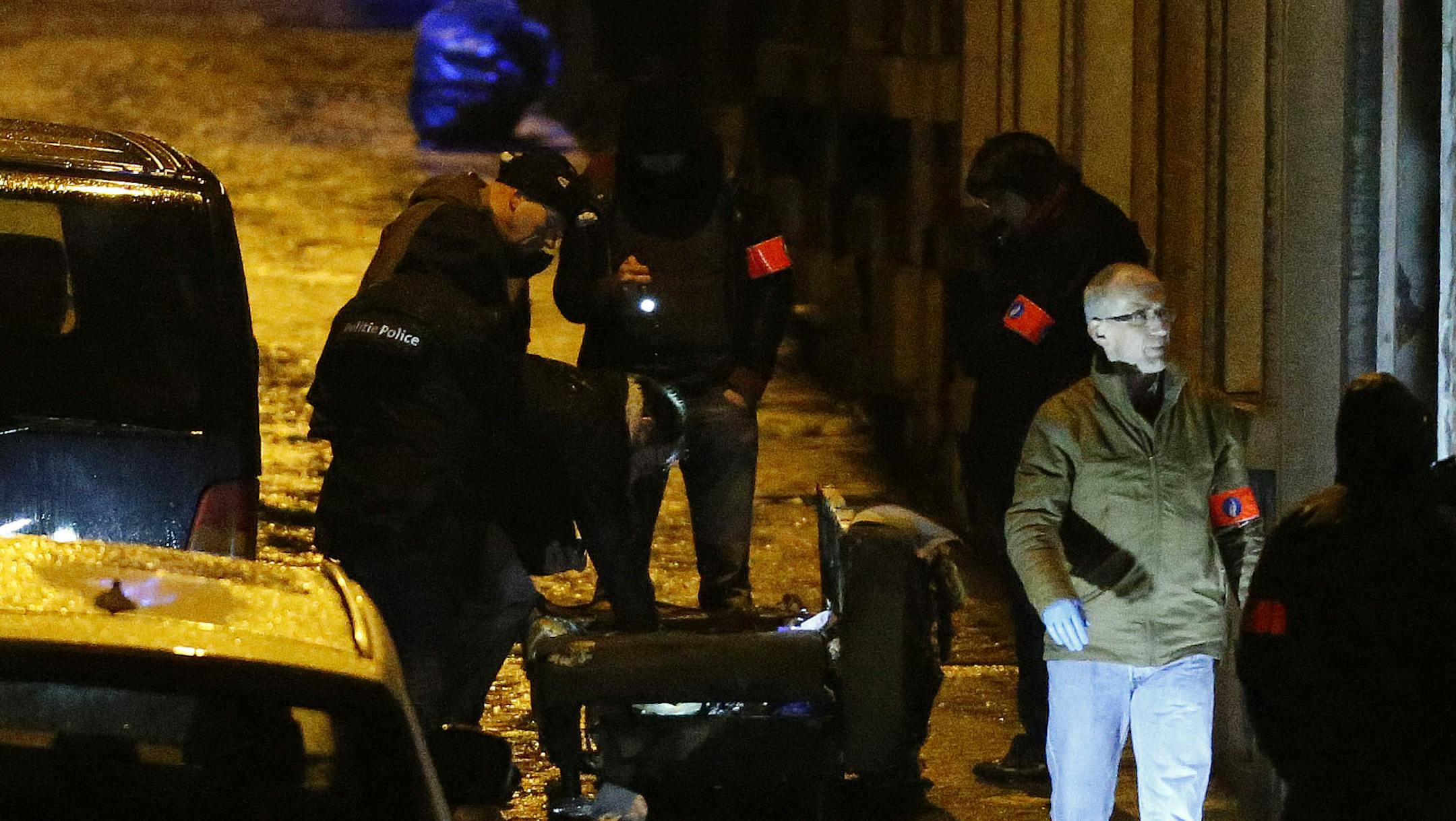Special police examine a street in Verviers, Belgium, Thursday, Jan. 15, 2015. Police blocks a street after security forces took part in anti-terrorist raids in Verviers, eastern Belgium. Belgian authorities say two people have been killed and one has been arrested during a shootout in an anti-terrorist operation in the eastern city of Verviers.(AP Photo/Frank Augstein)