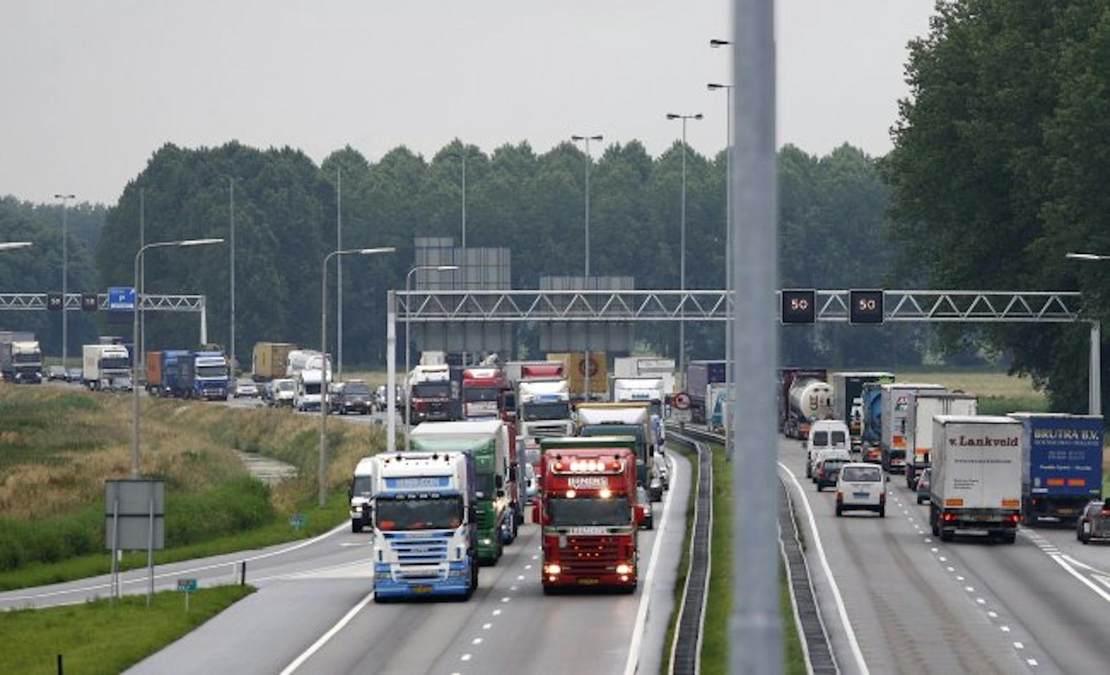 Trucks block the A15 highway near Hardinxveld-Giessendam, driving 50 kms per hour (31 miles per hour) to protest against Dutch government policy regarding high fuel prices. On 18 highways in the country, truck drivers drove 50 kms per hour for half an hour. Three days of strikes by thousands of truckers demanding measures to counter soaring fuel prices have also caused chaos and shortages across Spain and Portugal Portugal. AFP PHOTO / SANDER KONING -netherlands out - belgium out-
