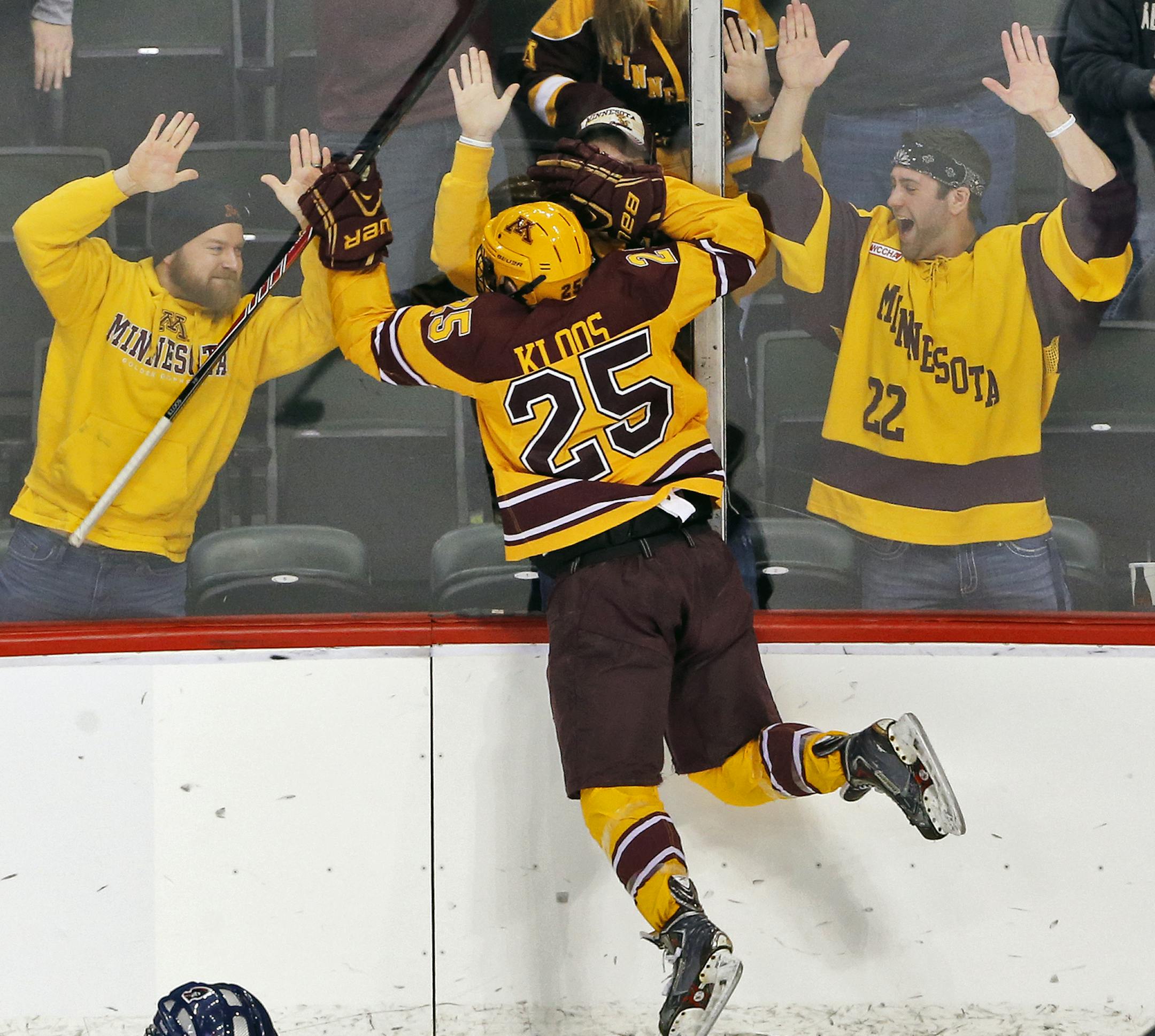 Gophers fans celebrate with Justin Kloos after he scored the third Minnesota goal in the first period. ] Minnesota Gophers vs. Robert Morris Colonials West Regional Hockey Tournament. (MARLIN LEVISON/STARTRIBUNE(mlevison@startribune.com)