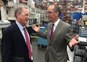 Chuck Rescorla, Graco's vice president of corporate manufacturing, visits Wednesday with U.S .Secretary of Labor Thomas Perez at Graco's flagship plan