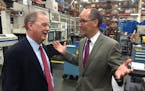 Chuck Rescorla, Graco's vice president of corporate manufacturing, visits Wednesday with U.S .Secretary of Labor Thomas Perez at Graco's flagship plan