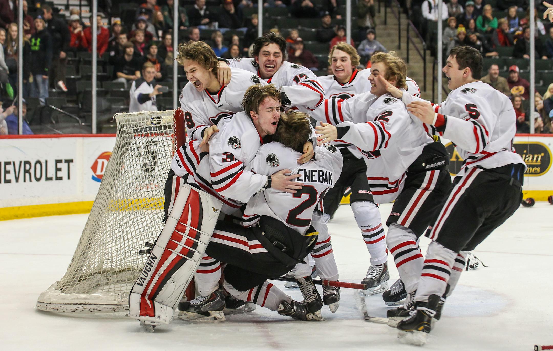 Lakeville North players including Henry Enebak mob goaltender Ryan Edquist in celebration of a 4-1 victory over Duluth East in the 2015 Class 2A state boys hockey championship game on March 7 at Xcel Energy Center in St. Paul. Photo by Mark Hvidsten