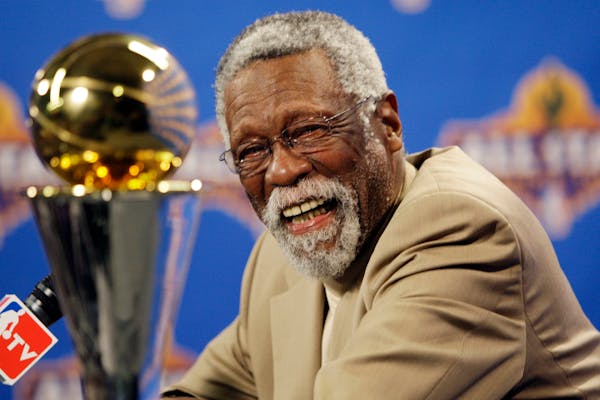 FILE - NBA great Bill Russell reacts at a as he learns the most valuable player award for the NBA basketball championships has been renamed the Bill R