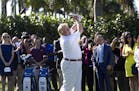Donald Trump hits a ceremonial tee shot off the first tee at Trump National Doral, February 6, 2014, in Doral, Fla. Trump says he is reversing his pla