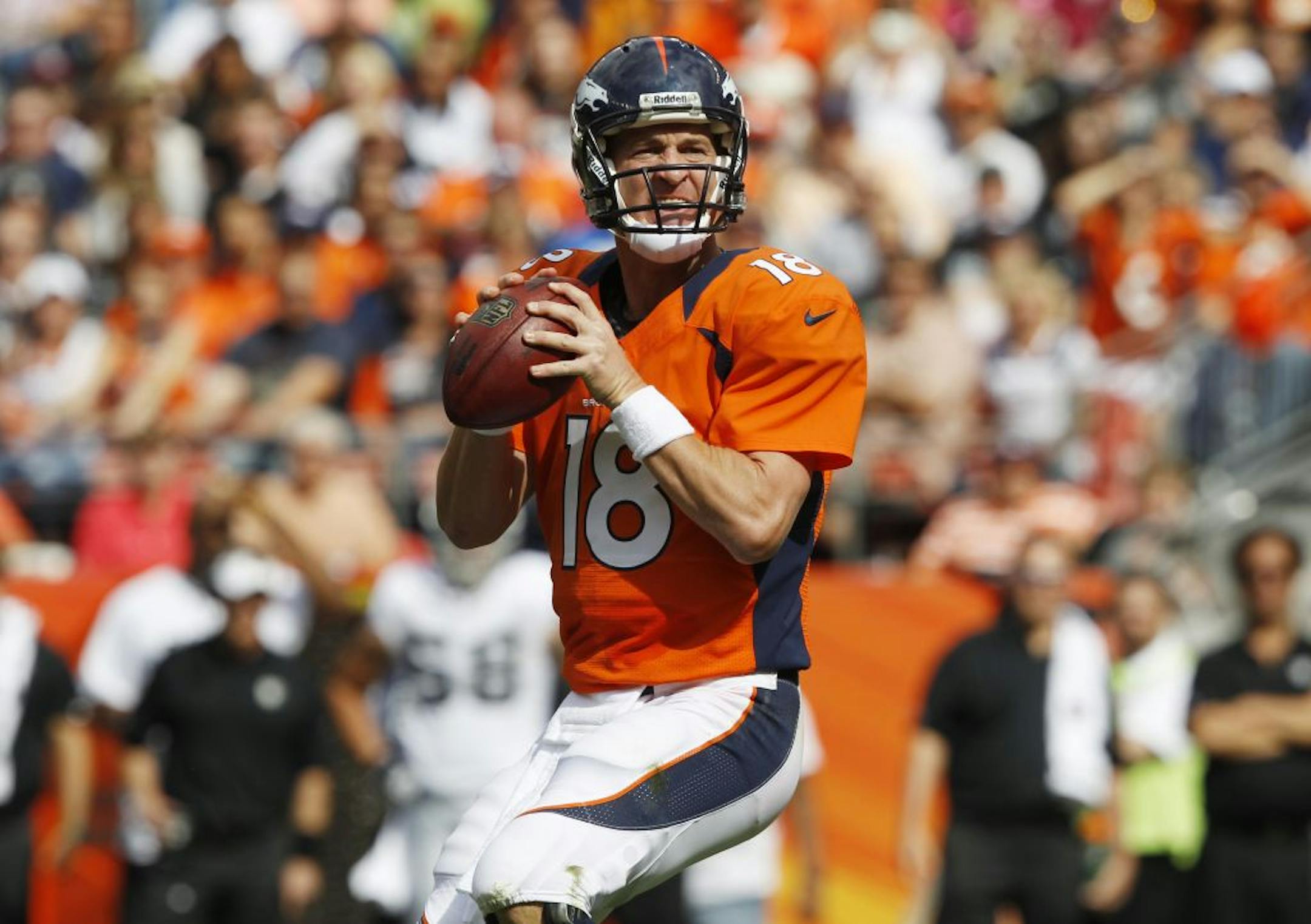 Denver Broncos quarterback Peyton Manning looks to pass against the Oakland Raiders during the first quarter of an NFL football game, Sunday, Sept. 30, 2012, in Denver.