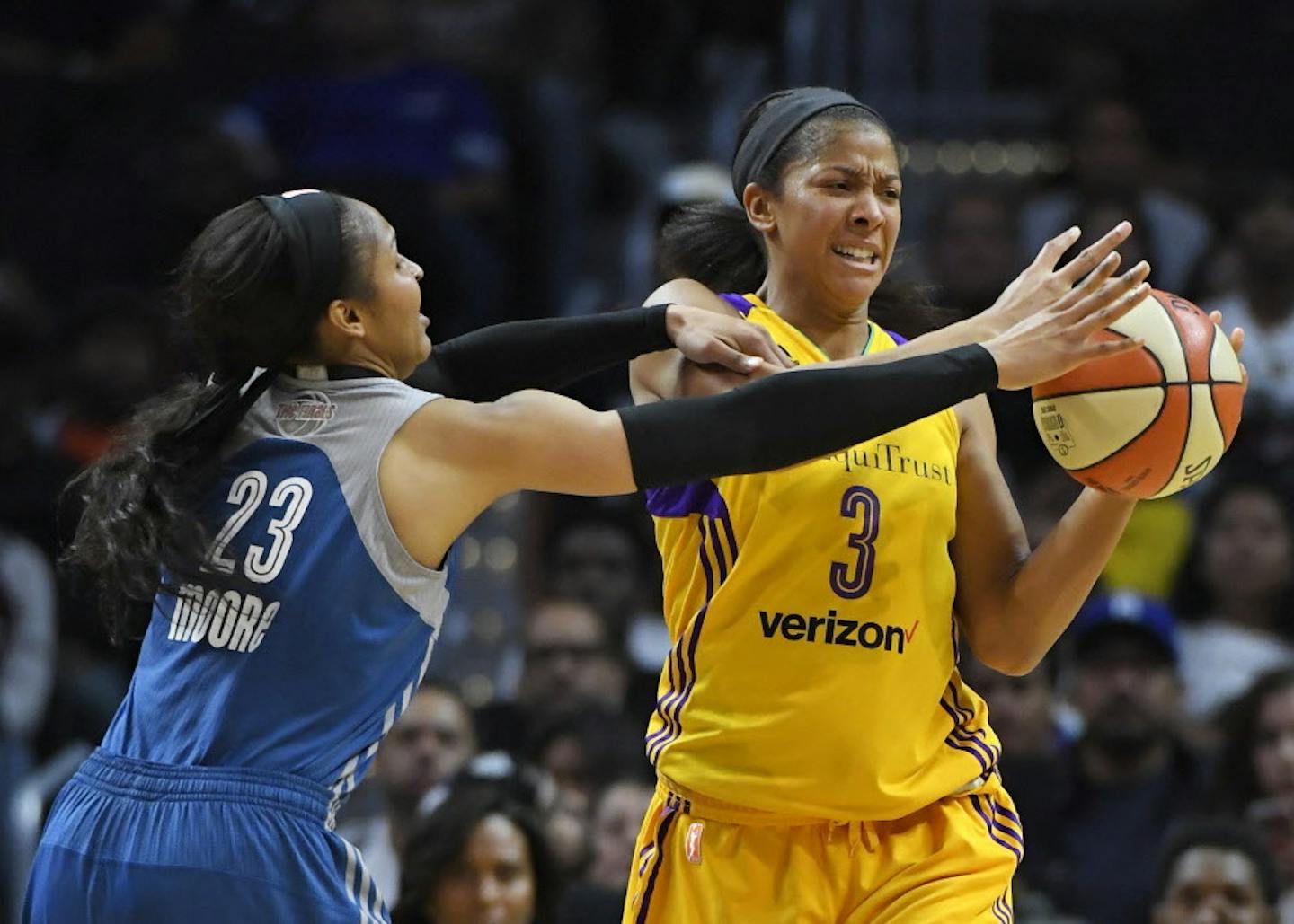 Minnesota Lynx forward Maya Moore, left, reaches in on Los Angeles Sparks forward Candace Parker during the first half in Game 4 of the WNBA basketball finals, Sunday, Oct. 16, 2016, in Los Angeles. (AP Photo/Mark J. Terrill)