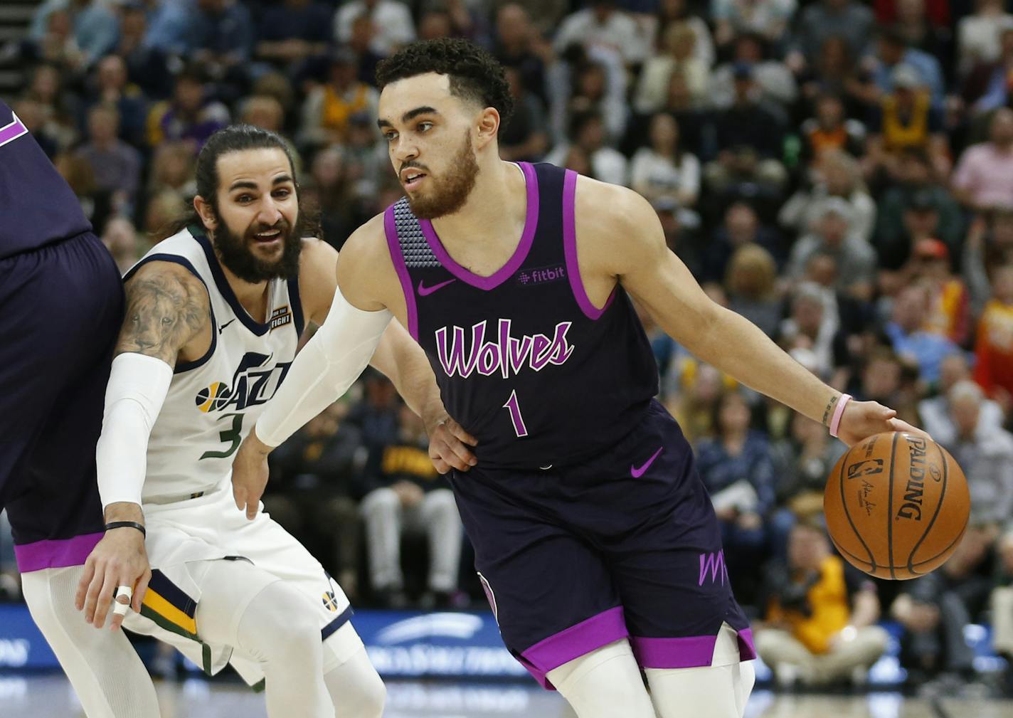 Minnesota Timberwolves guard Tyus Jones (1) drives around Utah Jazz guard Ricky Rubio (3) in the first half during an NBA basketball game Thursday, March 14, 2019, in Salt Lake City. (AP Photo/Rick Bowmer)