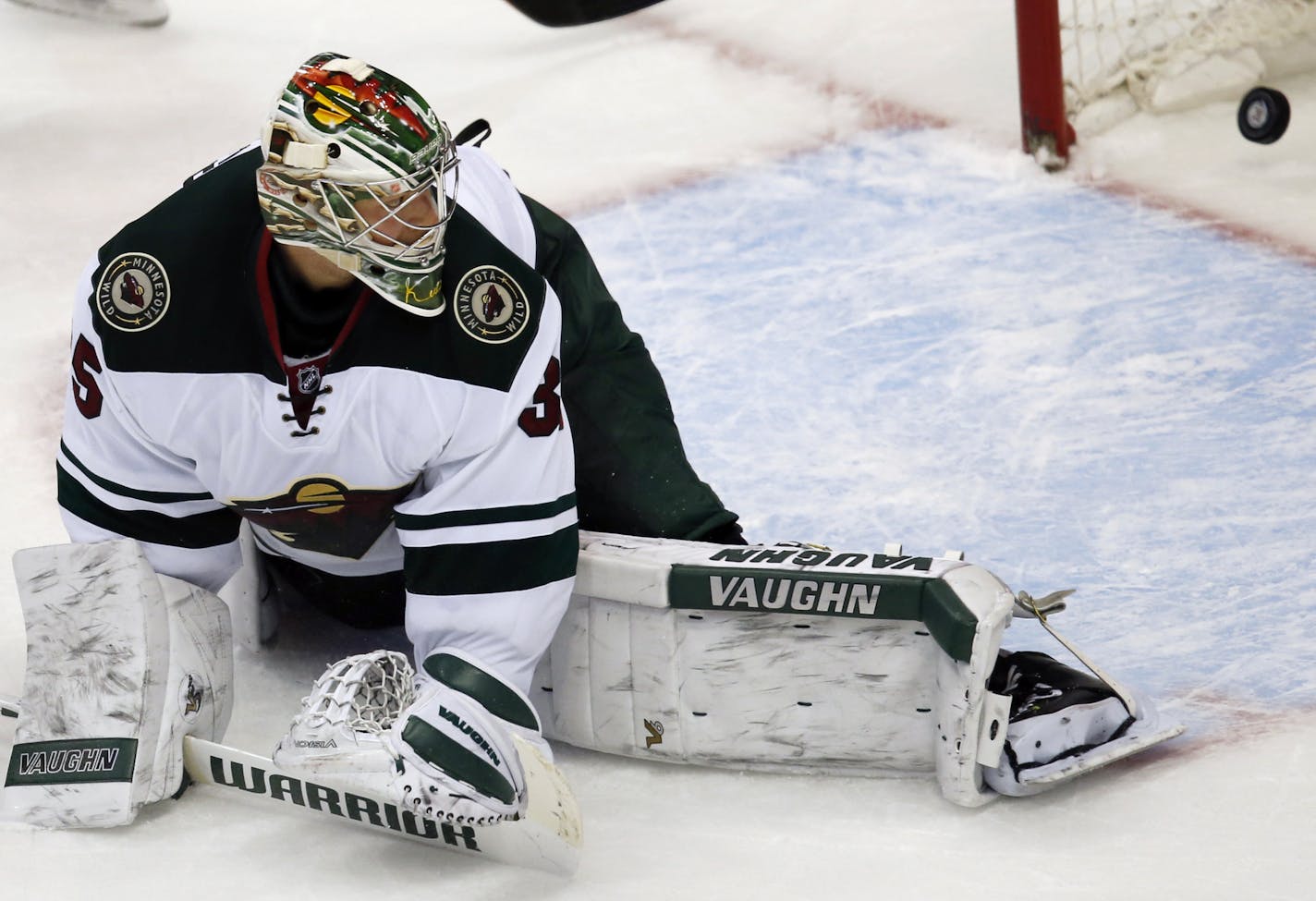 Minnesota Wild goalie Darcy Kuemper looks back into the net to see the puck go in for the game-winning goal off the stick of Colorado Avalanche center John Mitchell in the overtime period of an NHL hockey game Monday, Dec. 7, 2015, in Denver. Colorado won 2-1. (AP Photo/David Zalubowski)