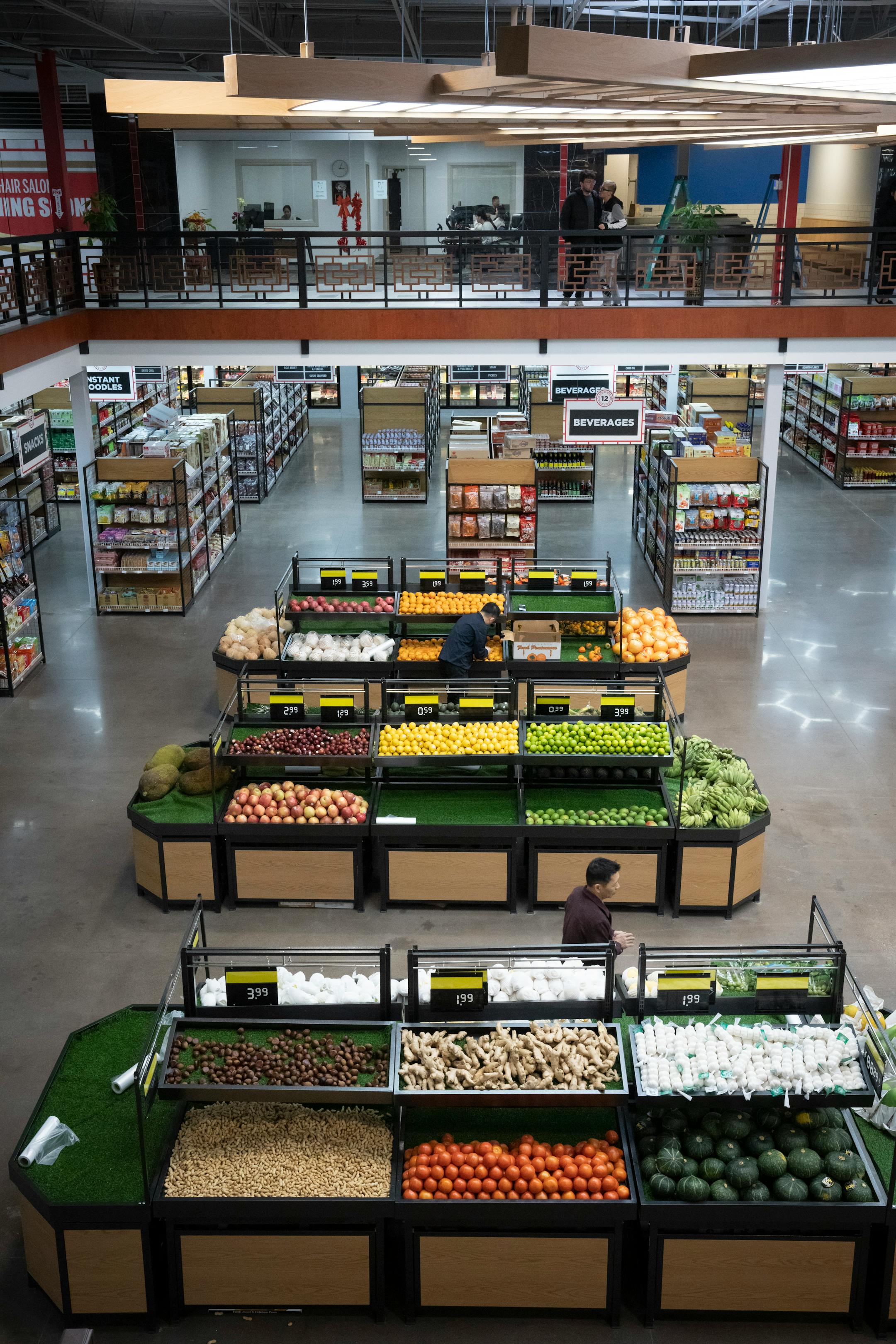 Produce at the grocery store was being set up for the soft opening for the new Asia Mall.