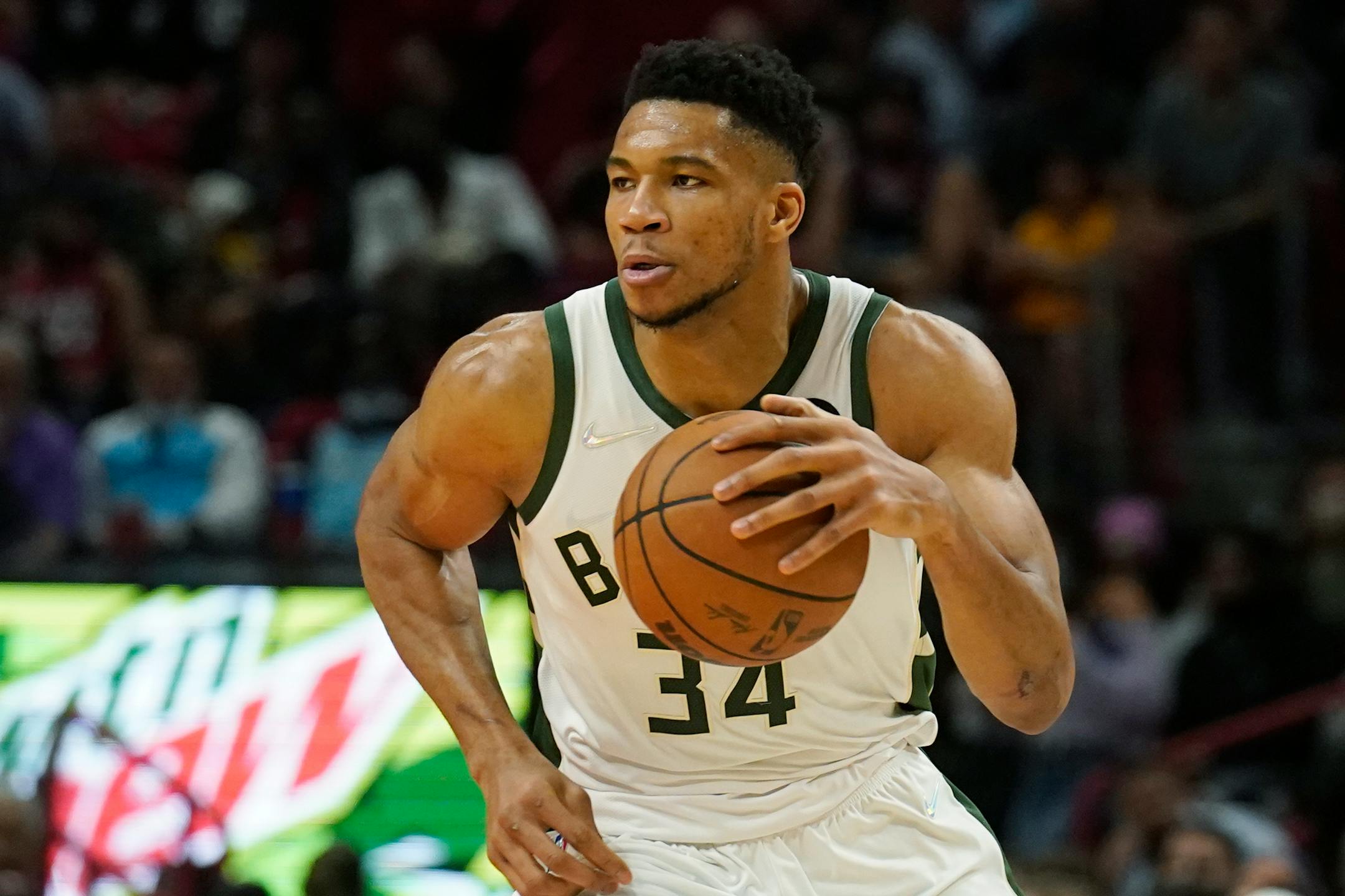 Milwaukee Bucks forward Giannis Antetokounmpo (34) dribbles the ball during the first half of an NBA basketball game against the Miami Heat, Wednesday, Dec. 8, 2021, in Miami. (AP Photo/Marta Lavandier)