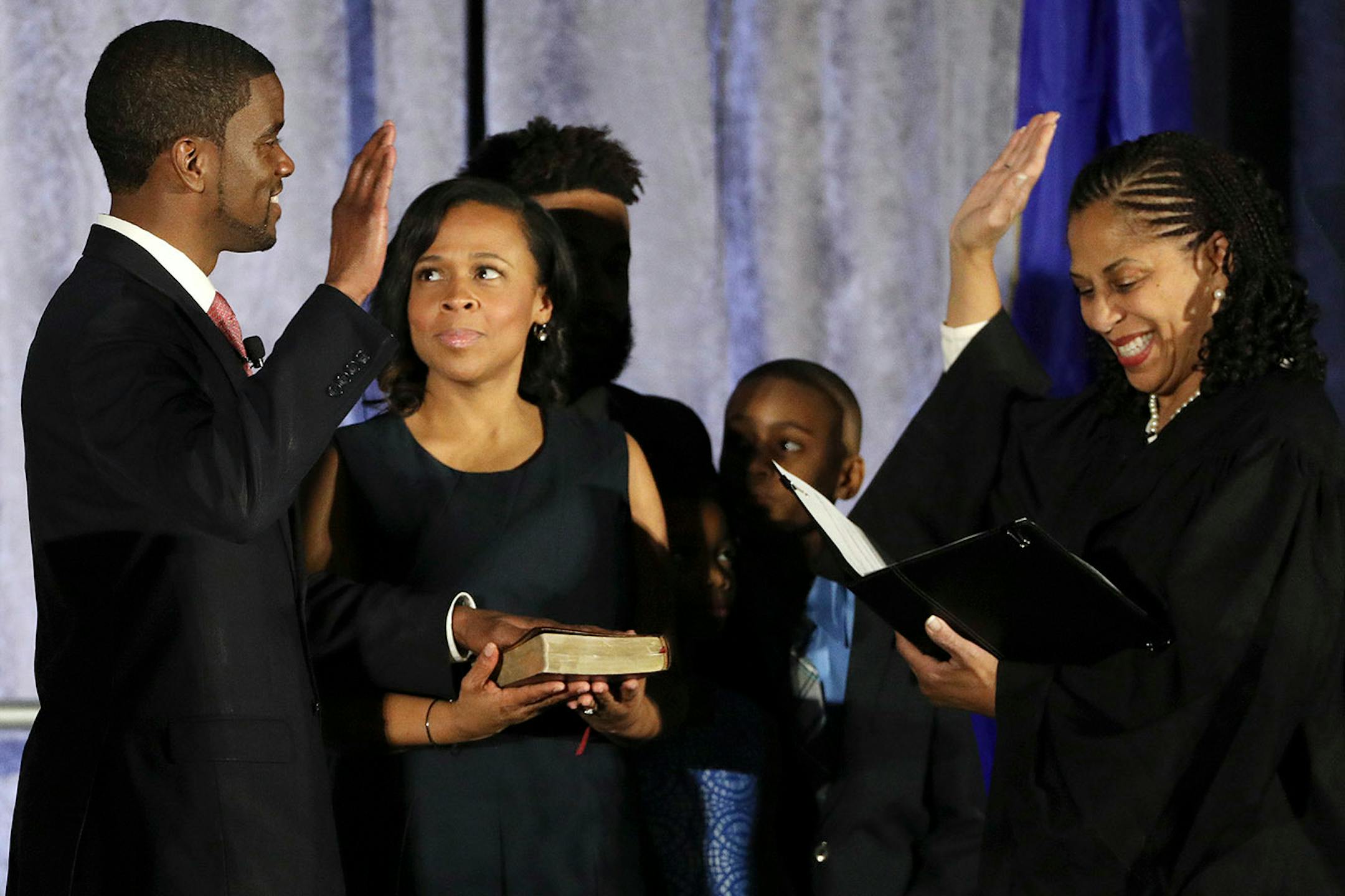 Melvin Carter and his wife Sakeena Carter were joined on stage by their family as Justice Tanya Bransford with the Fourth Judicial District administered the oath of office during Carter's swearing in ceremony as St. Paul mayor.