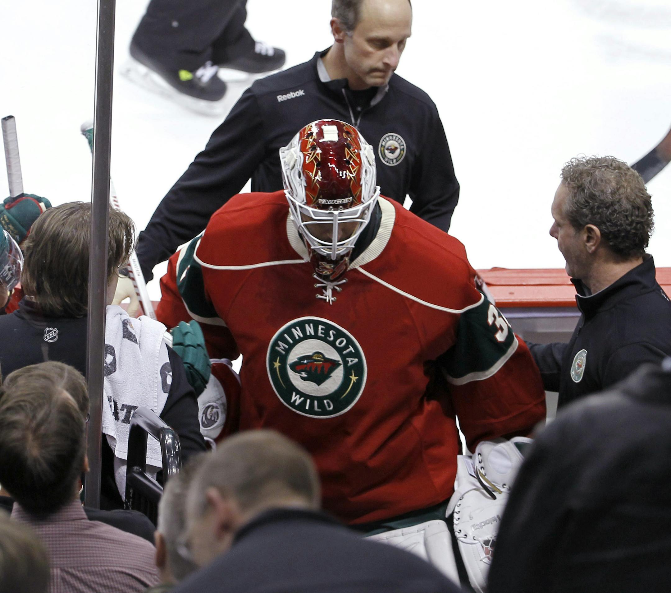 Minnesota Wild goalie Niklas Backstrom, center, of Finland, leaves the NHL hockey game against the Toronto Maple Leafs during the first period in St. Paul, Minn., Wednesday, Nov. 13, 2013. (AP Photo/Ann Heisenfelt)