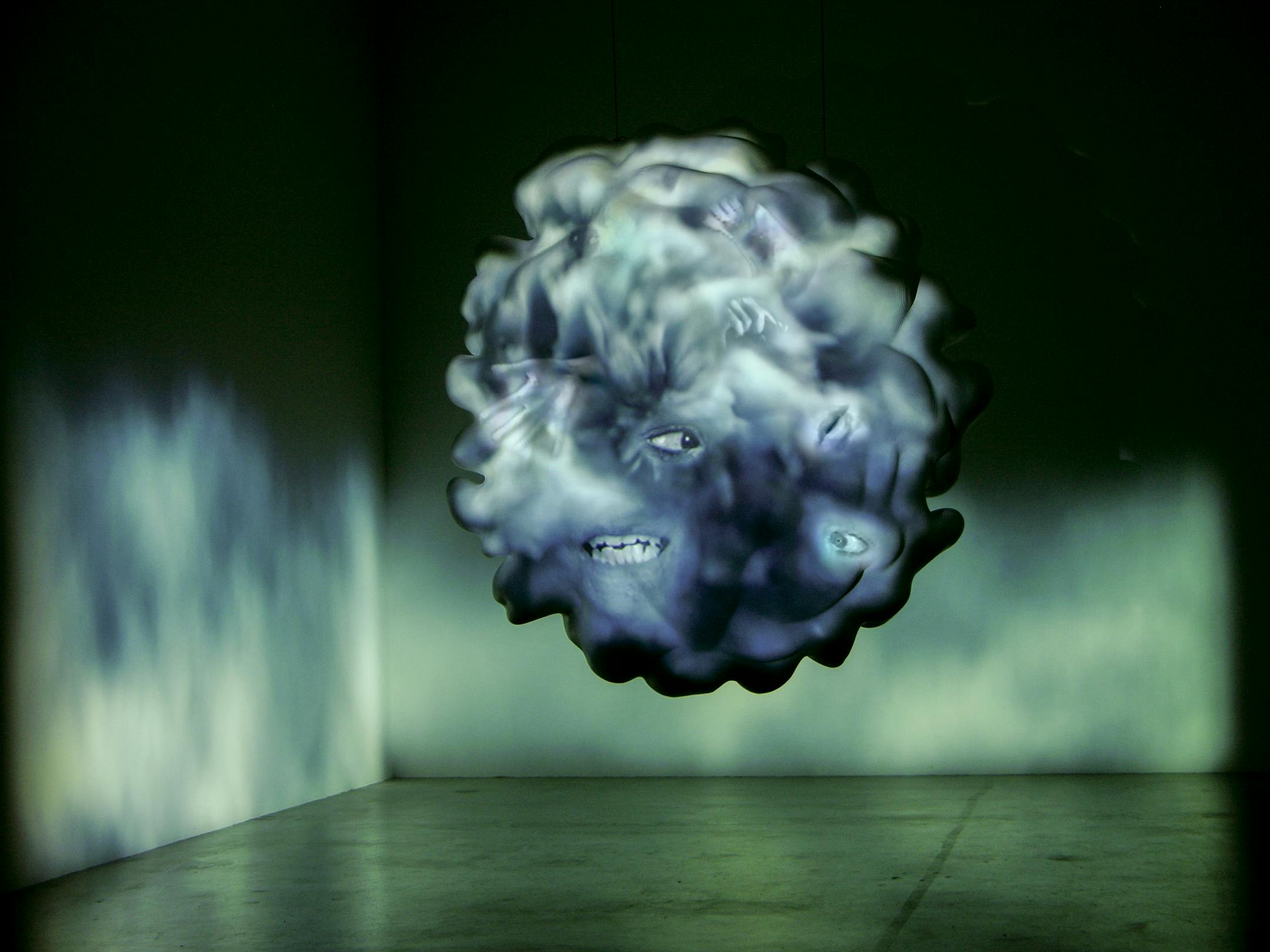 Tony Oursler. American, born 1957 Dust, from Thought Forms, 2006. Fiberglass sculpture, Haron Kardon HS100 5.1 sound system, Sony XGA VPL-PX41 projector, 2 Sanyo PLC-XU48 projectors, 3 DVD players, 6 DVDs, and 3 master tapes, 72 × 72 × 72 in. The Broad Art Foundation, Los Angeles CA, F-Ours-1S06.05. Photo: Courtesy Tony Oursler. © Tony Oursler.