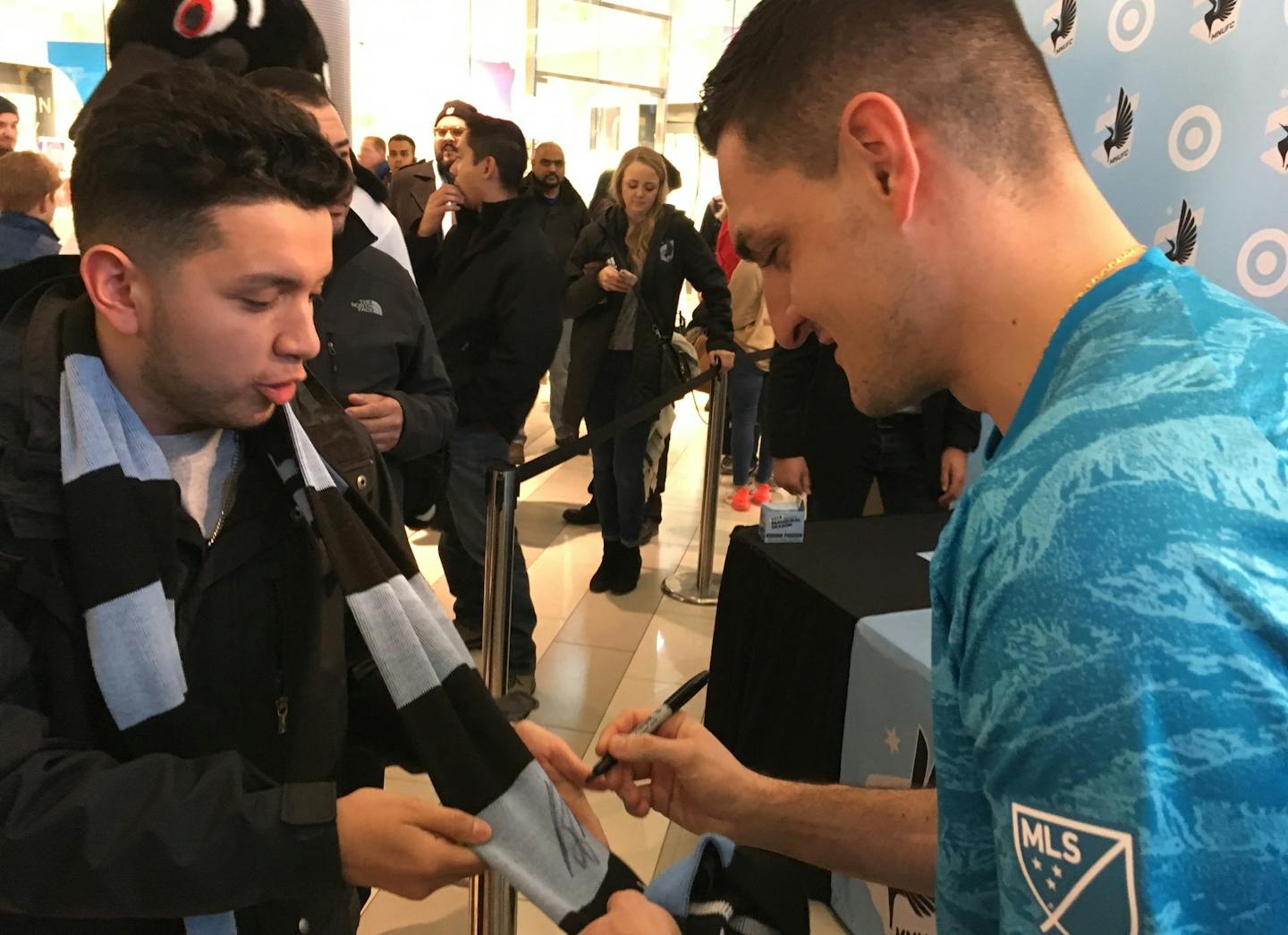 New Minnesota United goalkeeper Vito Mannone signed a supporters' scarf for a fan after the team showed off its new kits, or jerseys, for the 2019 season Sunday at the Mall of America.