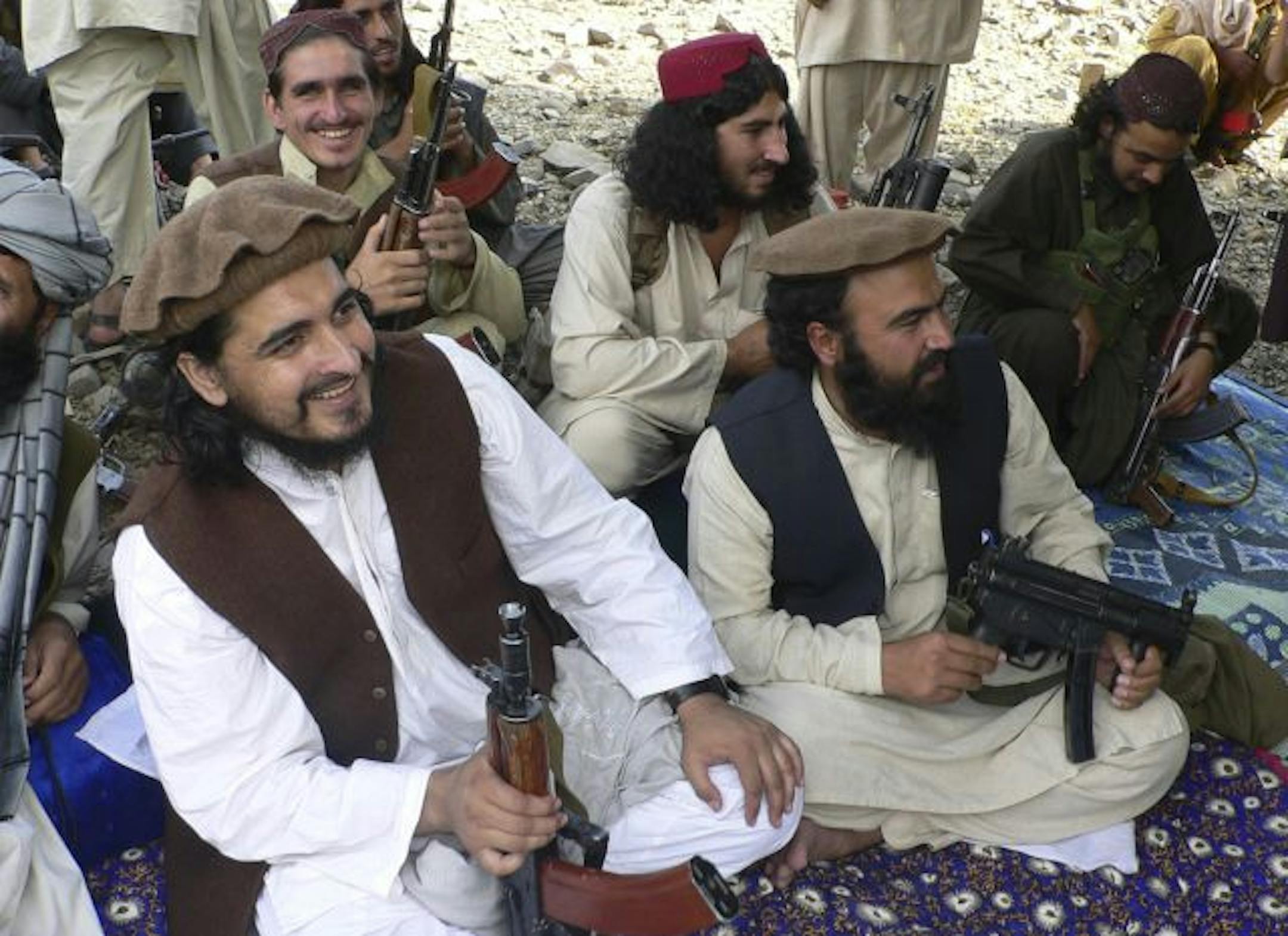 In this photo taken Sunday, Oct. 4, 2009, Pakistani Taliban chief Hakimullah Mehsud, left, is seen with his comrade Waliur Rehman, front center, during his meeting with media in Sararogha in the Pakistani tribal area of South Waziristan.