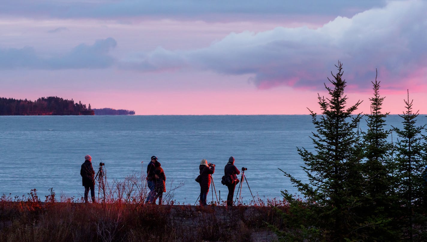 Attendees at the Aurora Summit in Two Harbors in November didn&#xed;t spot the Northern Lights, but they still did a lot of sky watching, including gathering on a beach on the North Shore to photograph a sunrise. Photograph by Peter Keller.