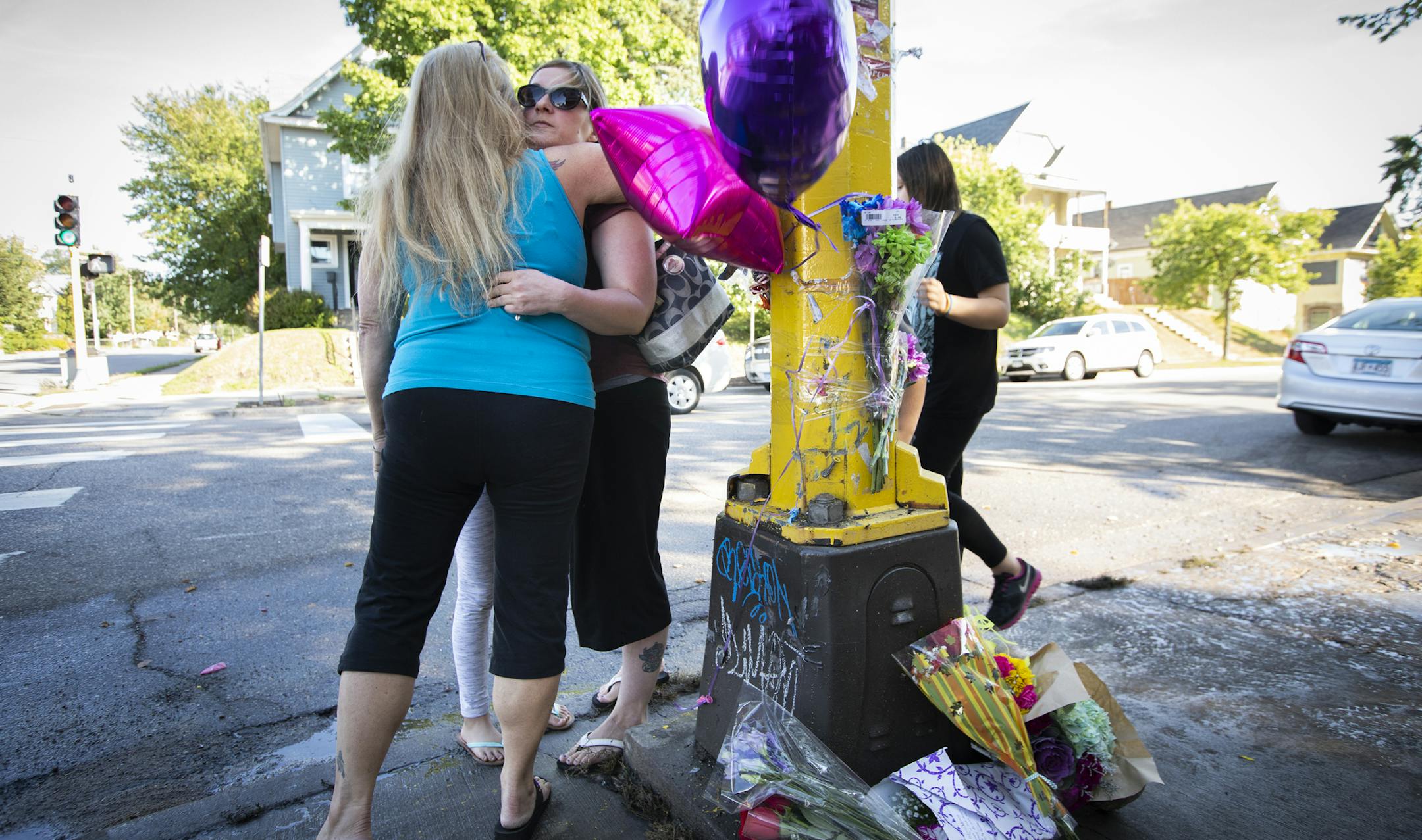 Those who identified only as extended members of the family of Sheryl and Kenneth Carpentier, two of the victims, hugged after putting up balloons and flowers on the growing memorial outside of Matt's Bar. ] LEILA NAVIDI &#xef; leila.navidi@startribune.com BACKGROUND INFORMATION: A memorial for the victims is seen outside of Matt's Bar in Minneapolis on Sunday, September 23, 2018. A teenager speeding from state troopers in a stolen SUV hit another vehicle and killed three people early Sunday at