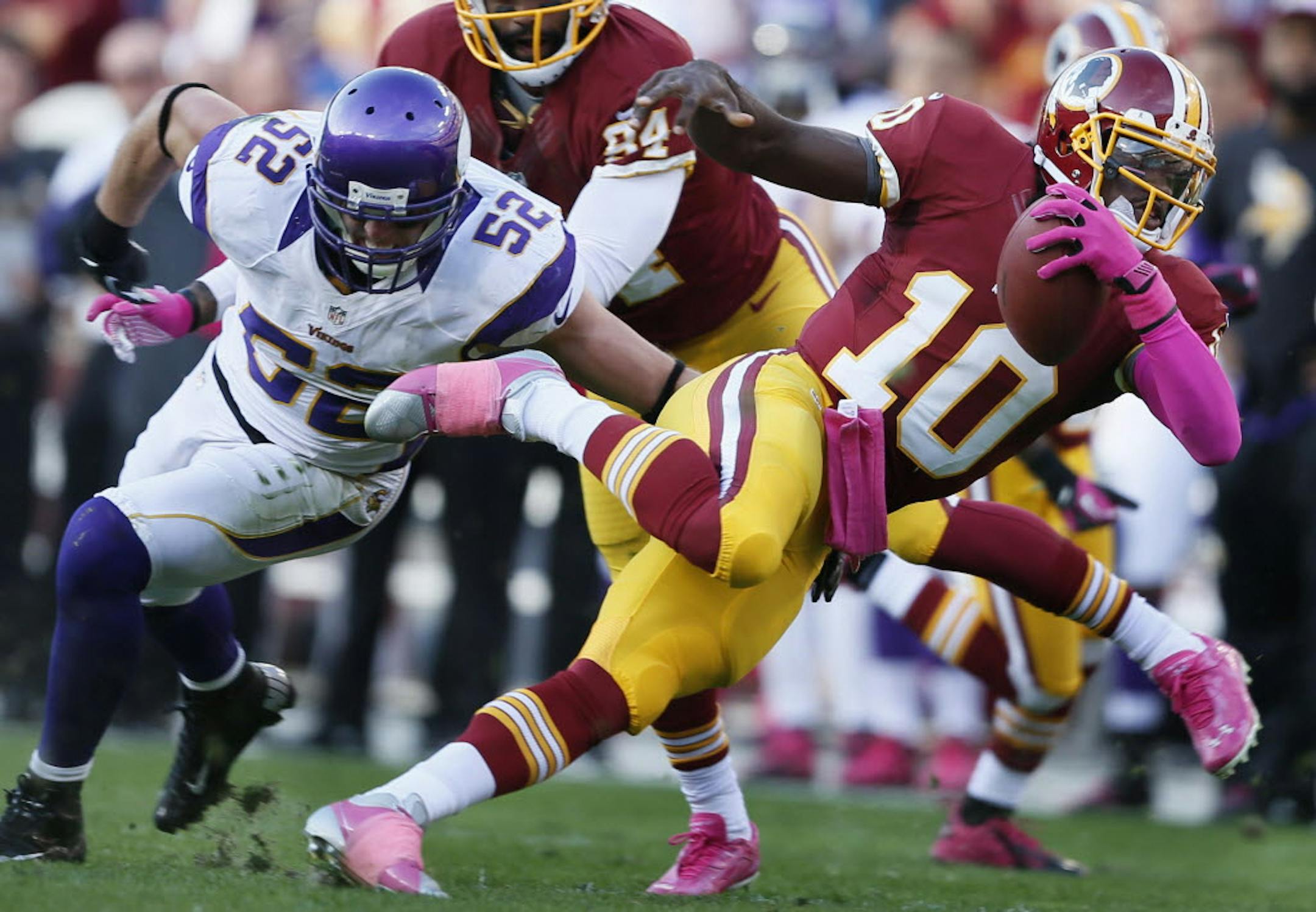Robert Griffin III eluded Vikings linebacker Chad Greenway on a run for a first down.