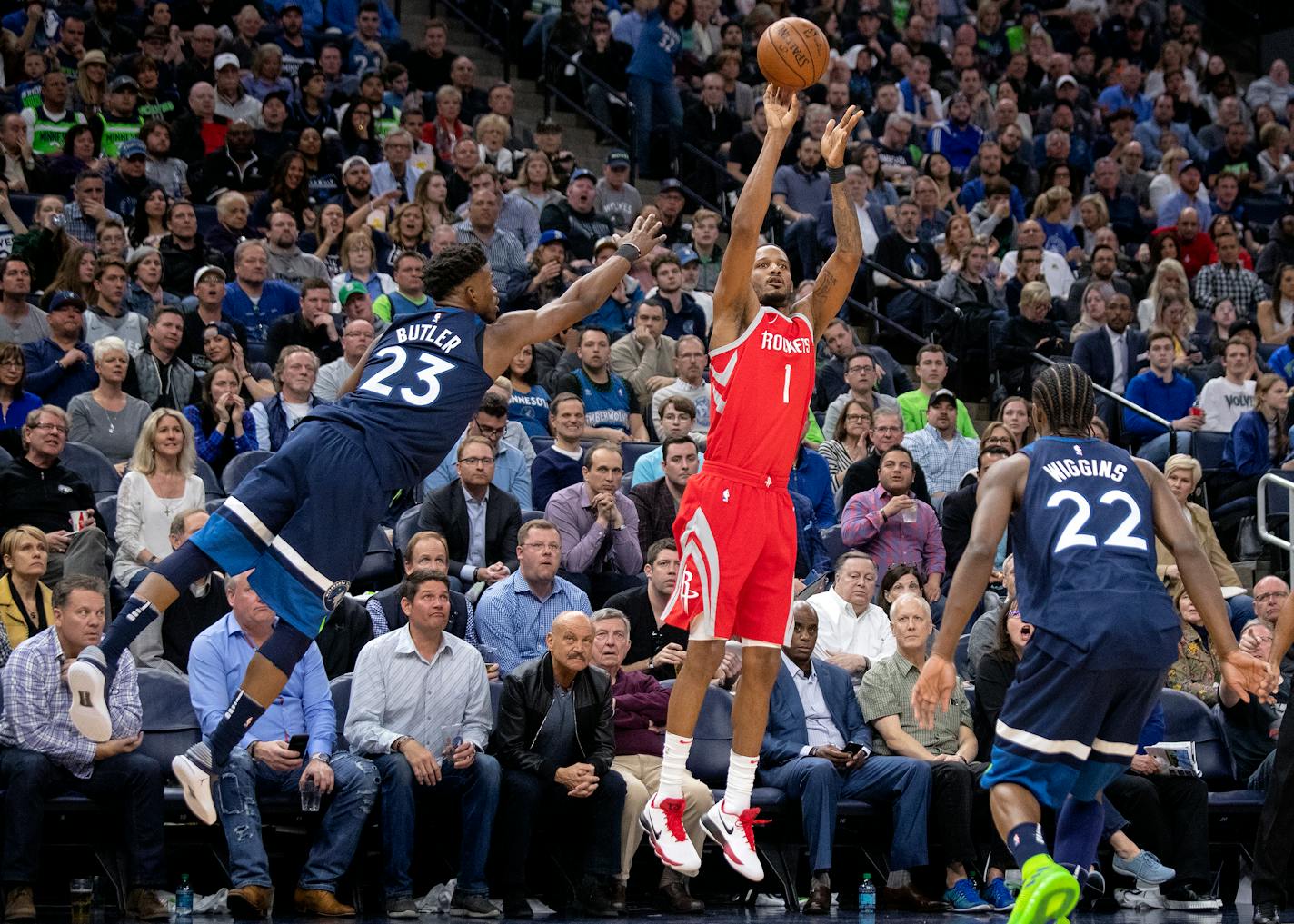 The Rockets' Trevor Ariza shot under pressure from Wolves guard Jimmy Butler (23) and Andrew Wiggins in the third quarter in Game 3 Saturday at Target Center.