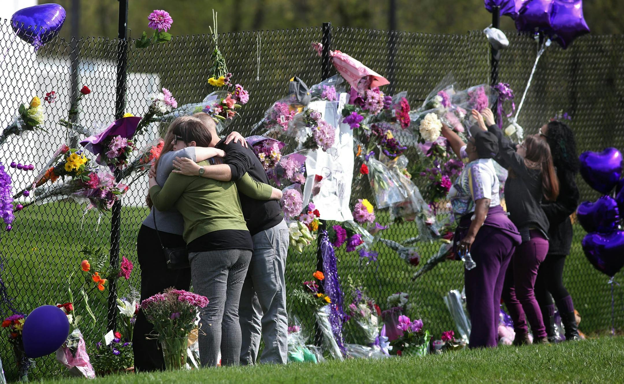 Mourners embraced after placing flowers at the makeshift memorial.